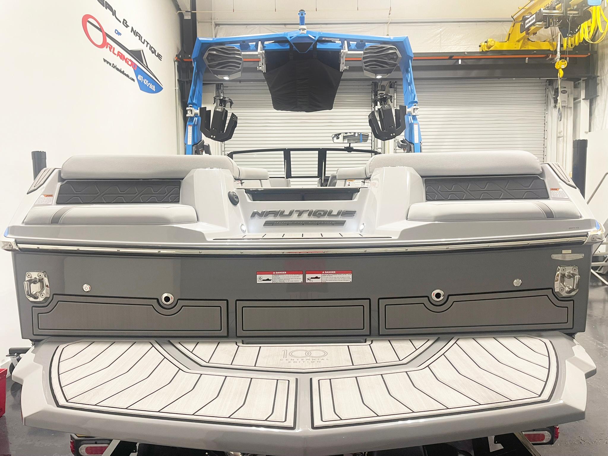 2025 Nautique Super Air Nautique GS24 boat, rear view in showroom setting.