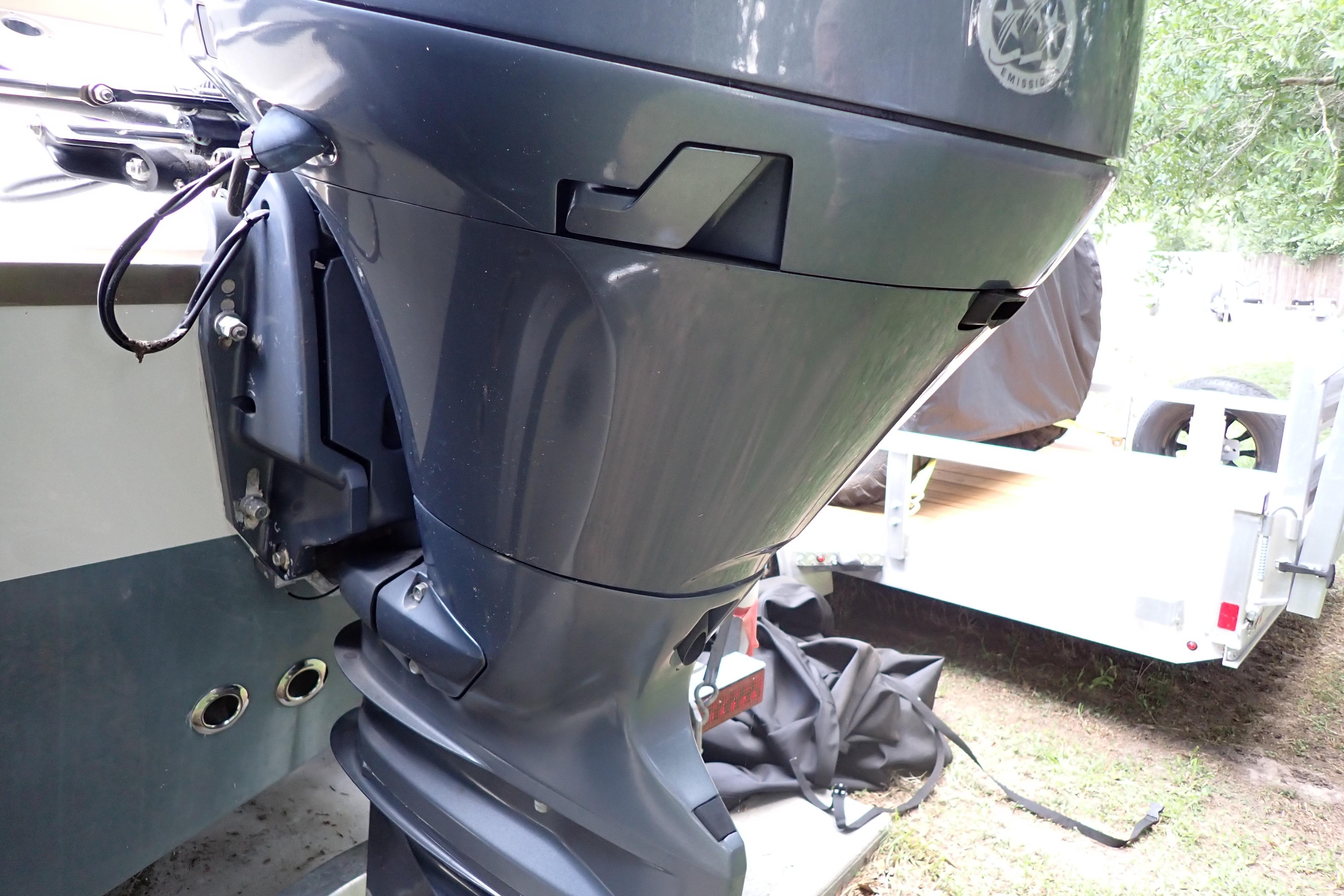 2019 Key West 263 FS boat motor, close-up view, parked outdoors.