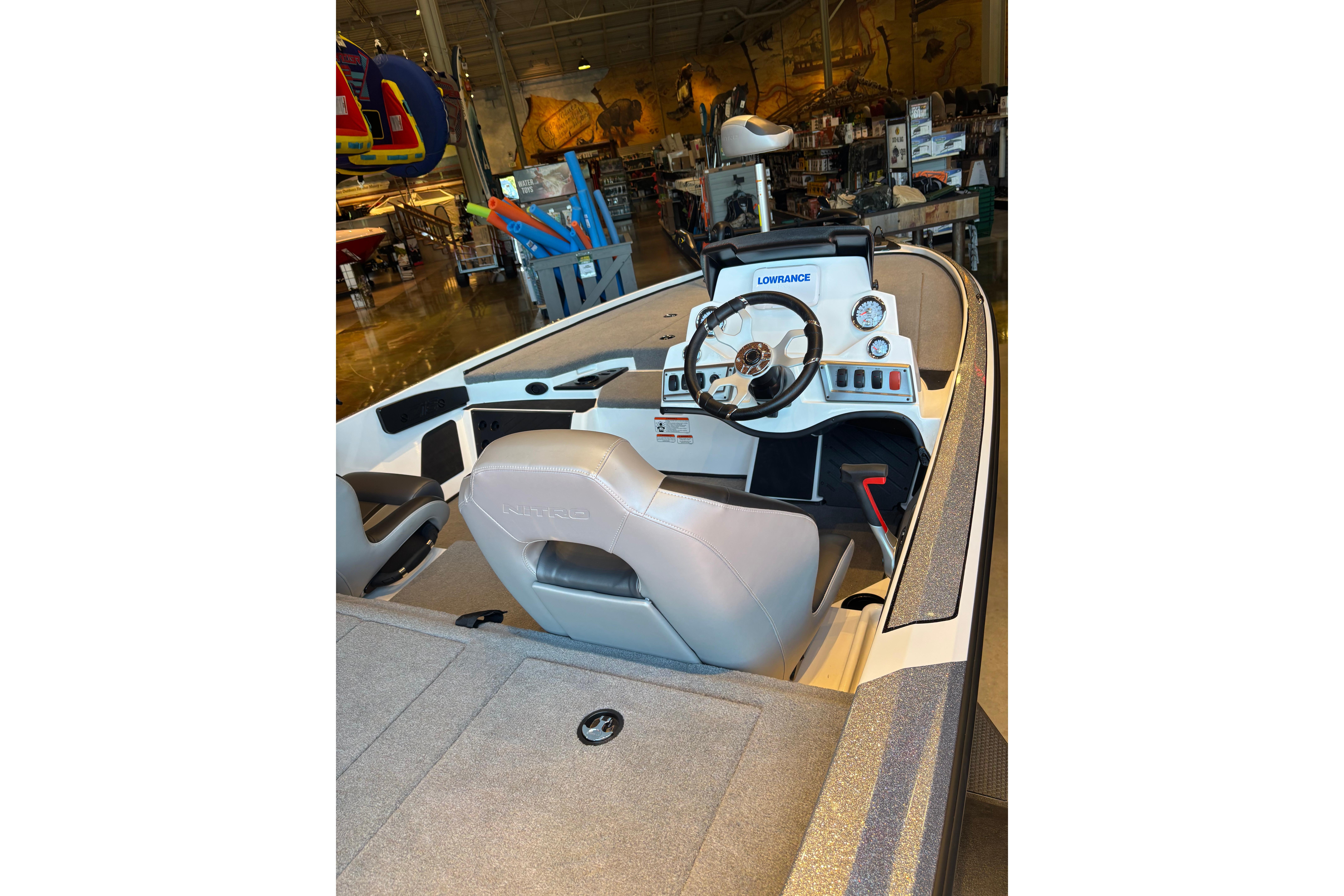 2025 Nitro Z18 boat interior with steering wheel and dashboard in showroom.