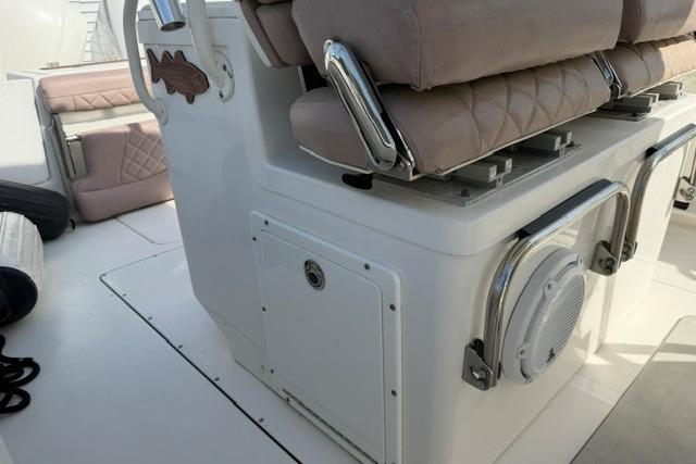 2014 Edgewater 318CC boat interior with cushioned seating and storage compartments.