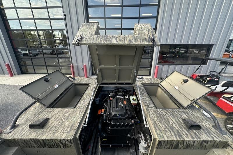 2025 SeaArk Predator 300 AK boat engine compartment with open hatches, showcasing interior details.
