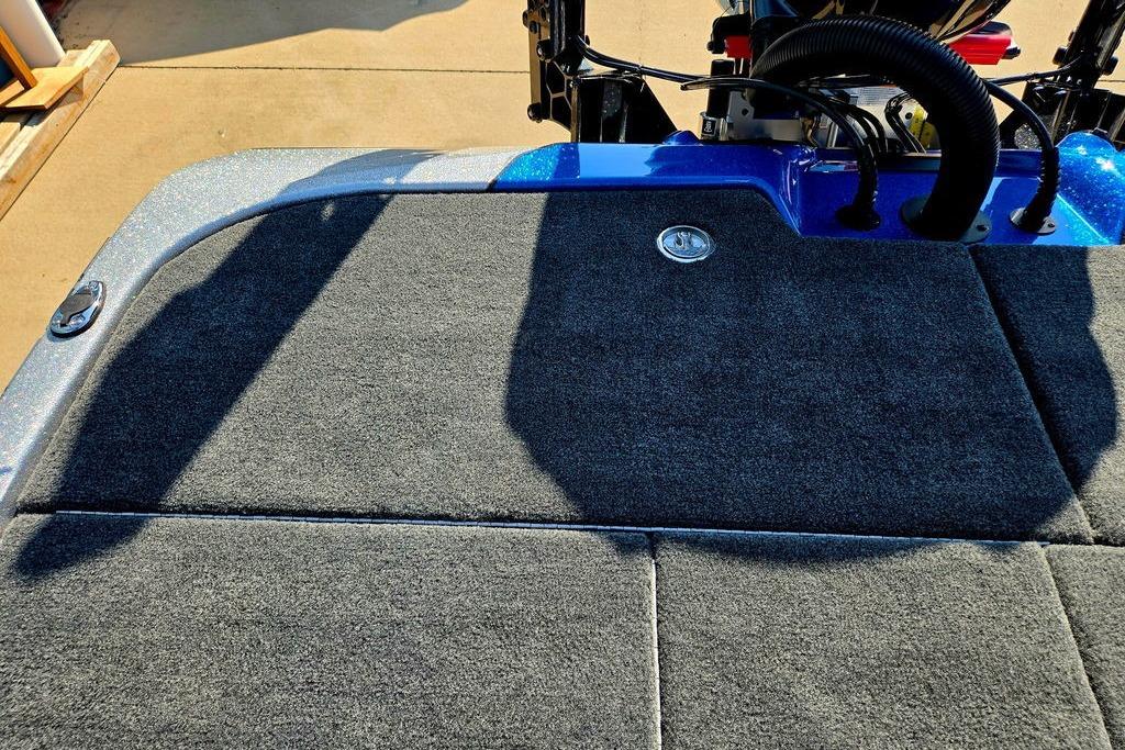 Rear deck of 2026 Skeeter ZXE20 boat with carpeted surface and engine components.