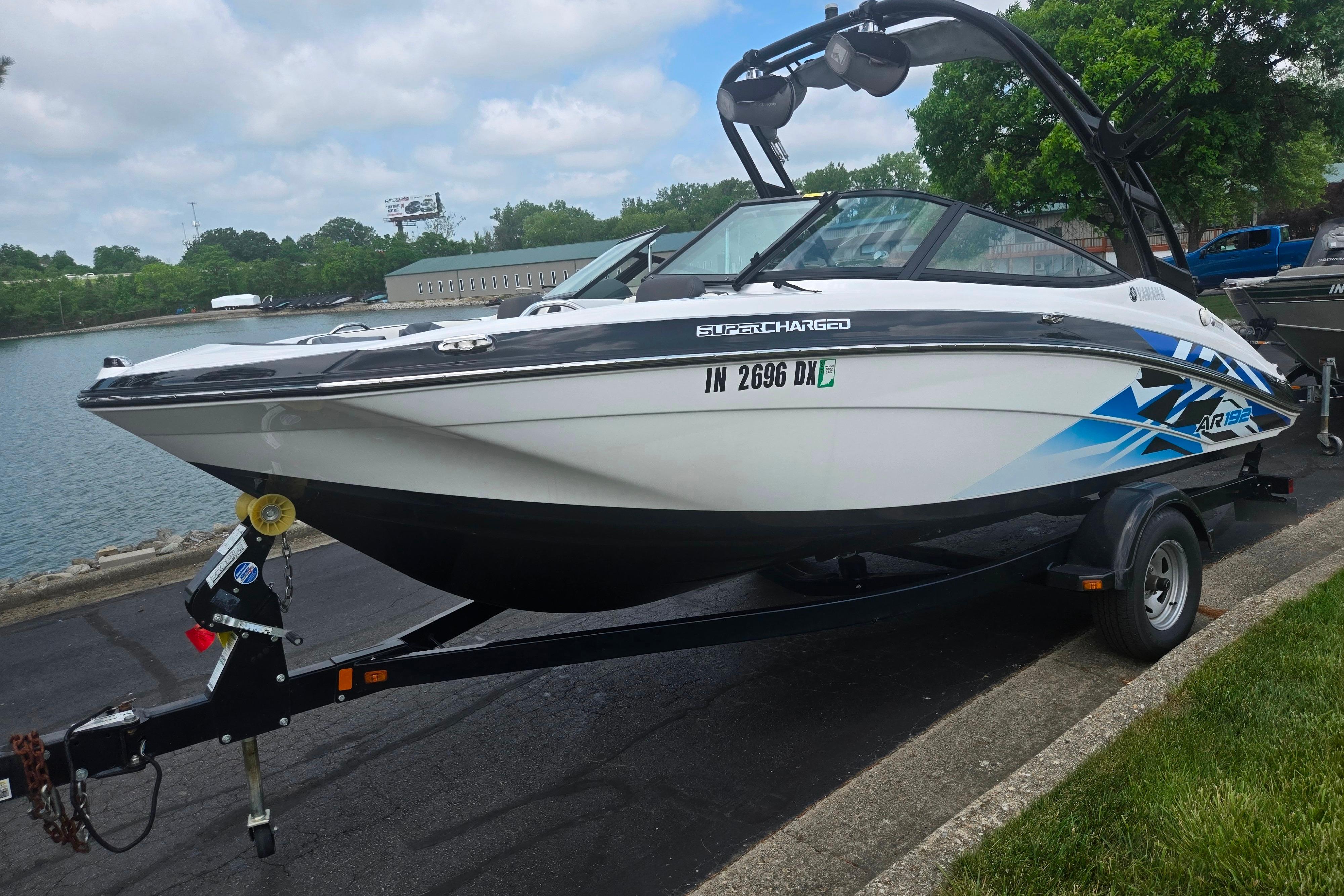 2016 Yamaha Boats AR192 on trailer by lakeside, featuring sleek design and vibrant graphics.