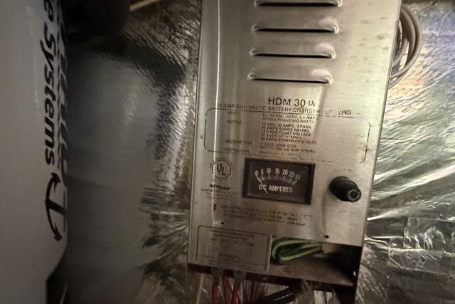 Battery charger in a 1986 Fexas Custom 57 boat, showing DC amperes gauge.