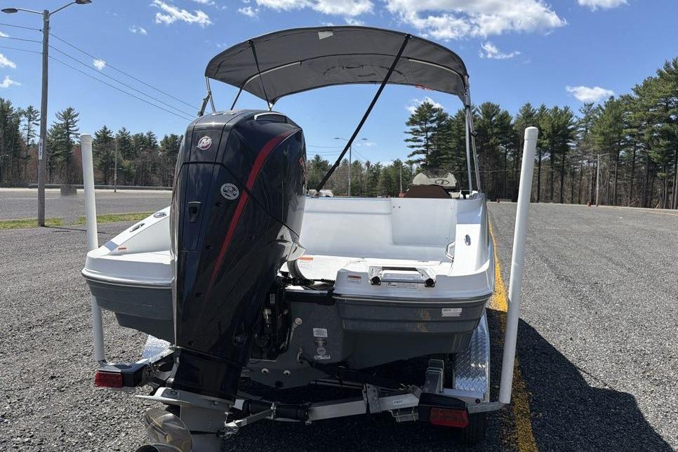 2026 Tahoe 1950 boat with outboard motor on trailer, parked in sunny outdoor setting.