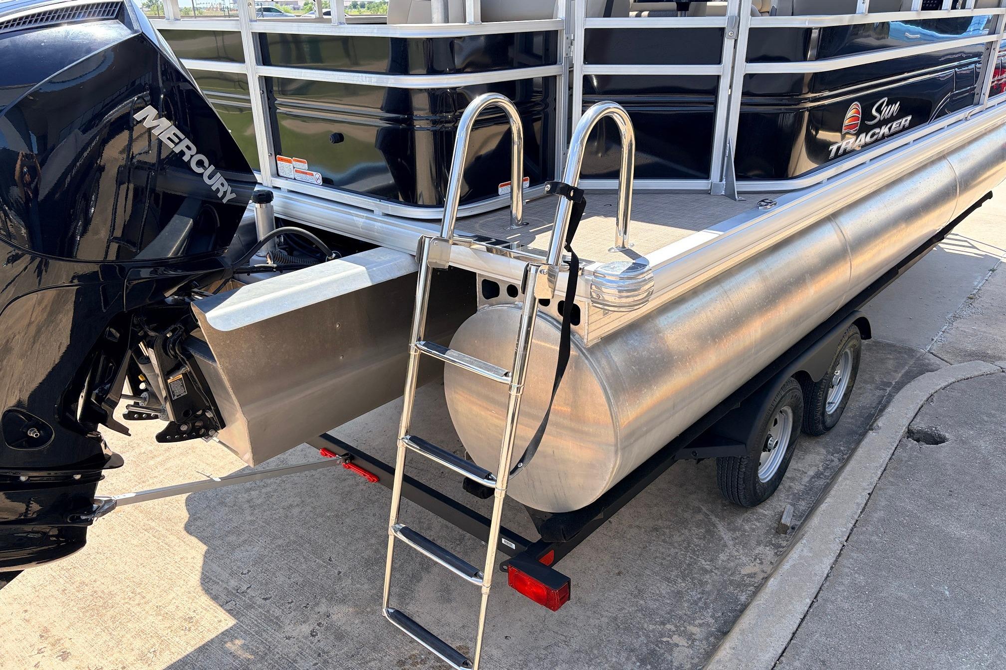 2024 Sun Tracker SportFish 22 XP3 pontoon boat with Mercury engine and ladder.