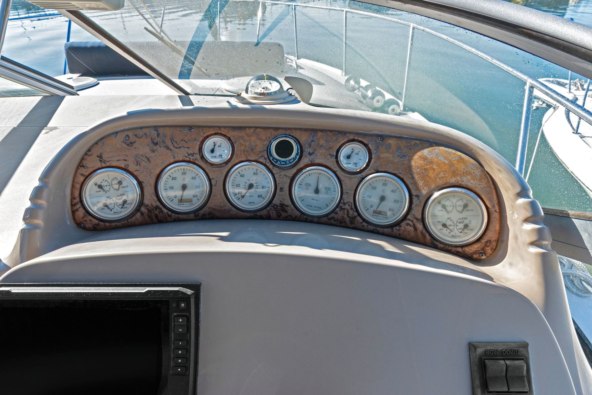 The dashboard of a 2007 Larson Cabrio 330 with multiple gauges and a screen.