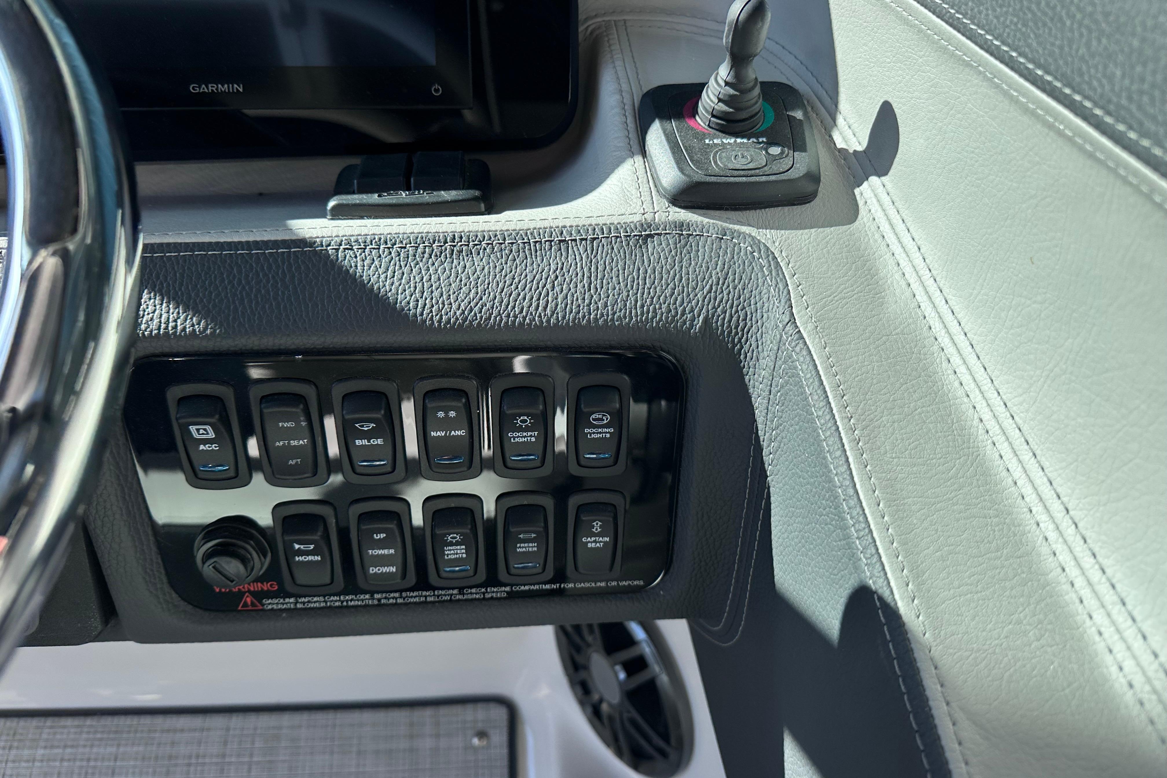 2026 Regal LX4 boat dashboard with control switches and Garmin display.
