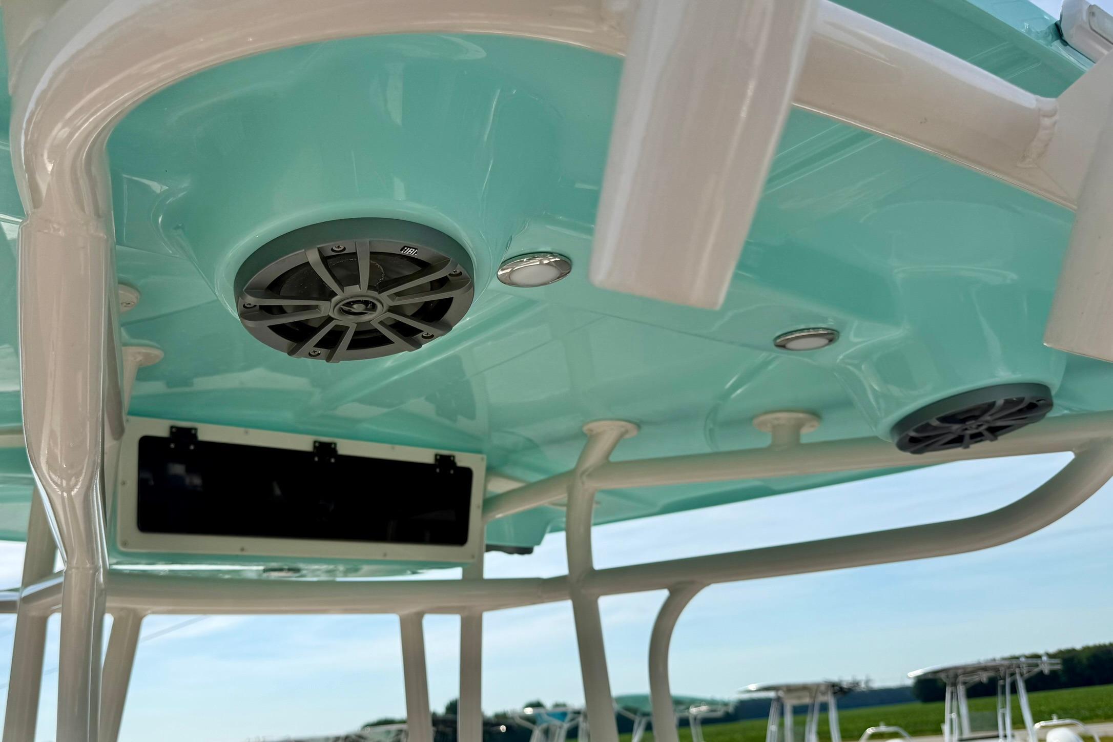 2026 Carolina Skiff 24 Ultra Elite boat interior with speakers and teal ceiling.