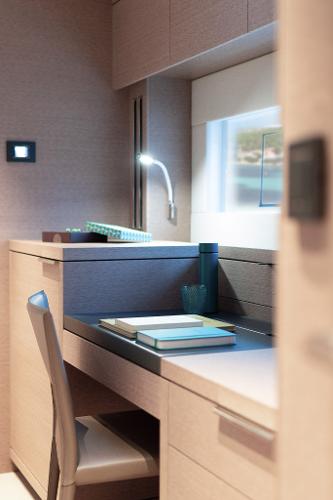 Modern study area in 2025 Lagoon SIXTY 5 yacht with sleek design and ambient lighting.