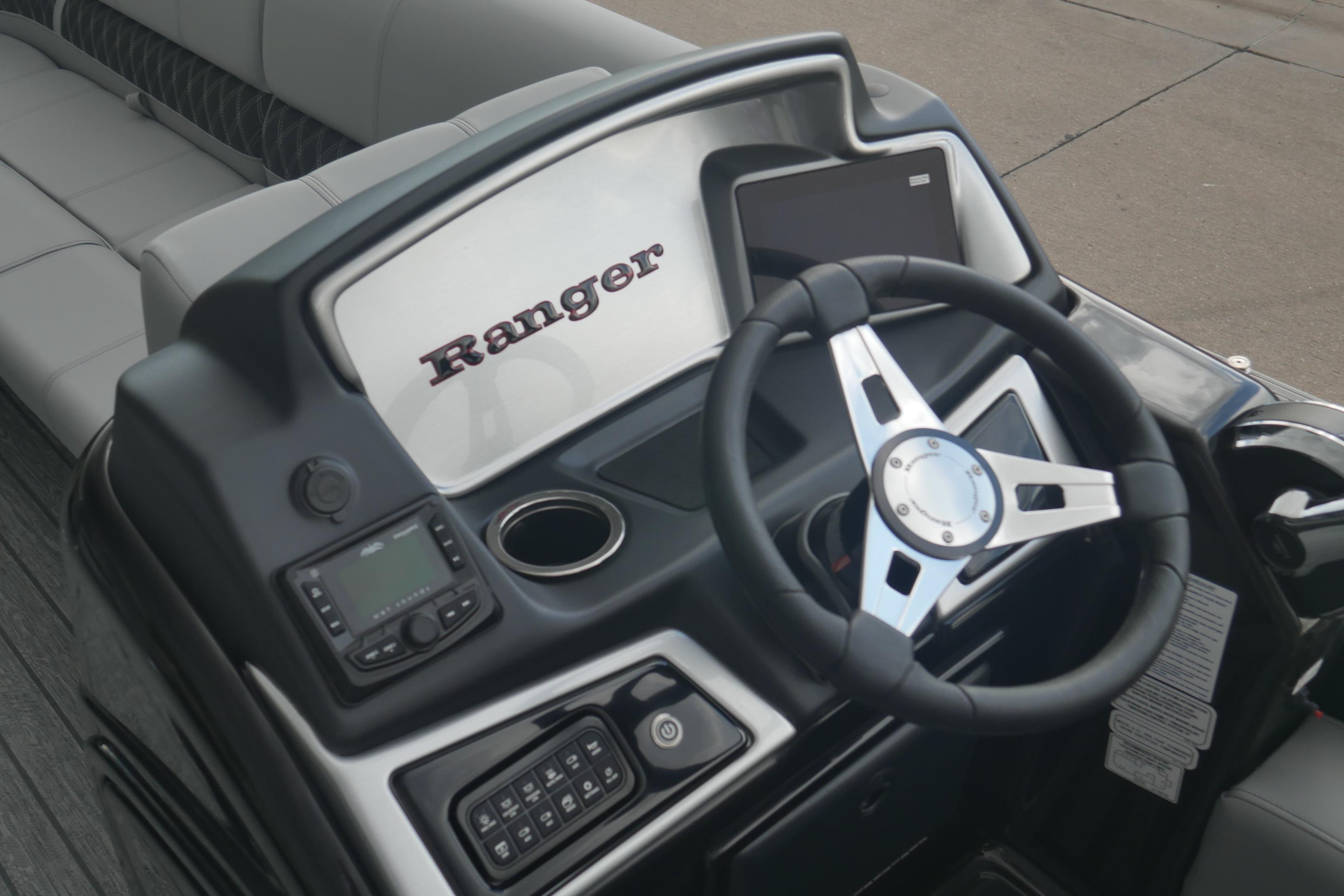 Steering console of 2026 Ranger 220FC boat with modern controls and seating.