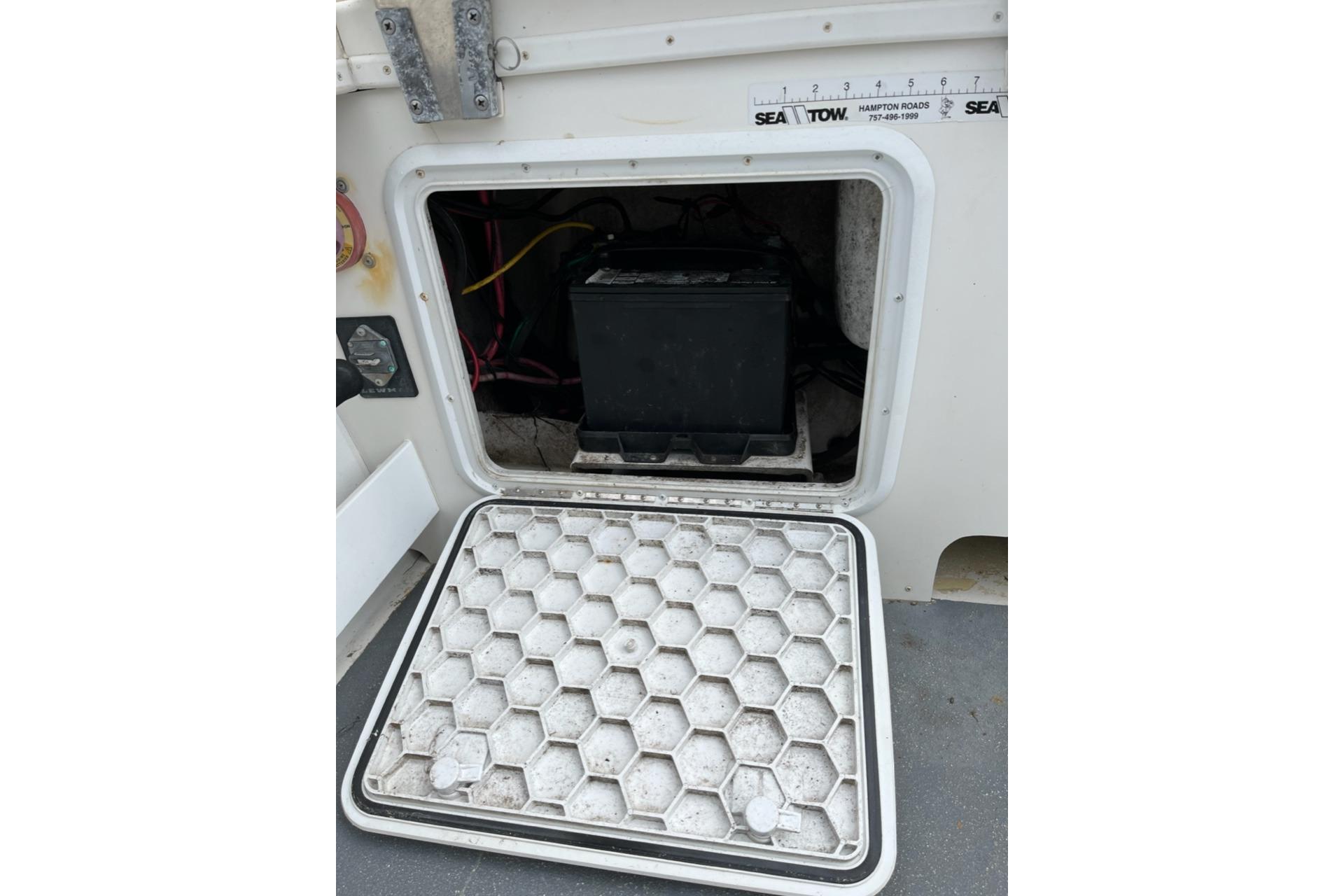 Battery compartment of a 2012 Steiger Craft Miami boat with open hatch.