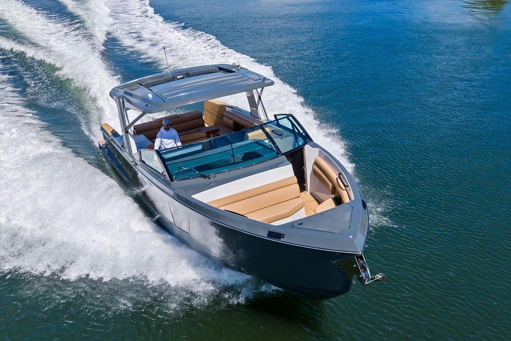 2022 Aviara AV40 OB luxury boat cruising on a clear blue lake.