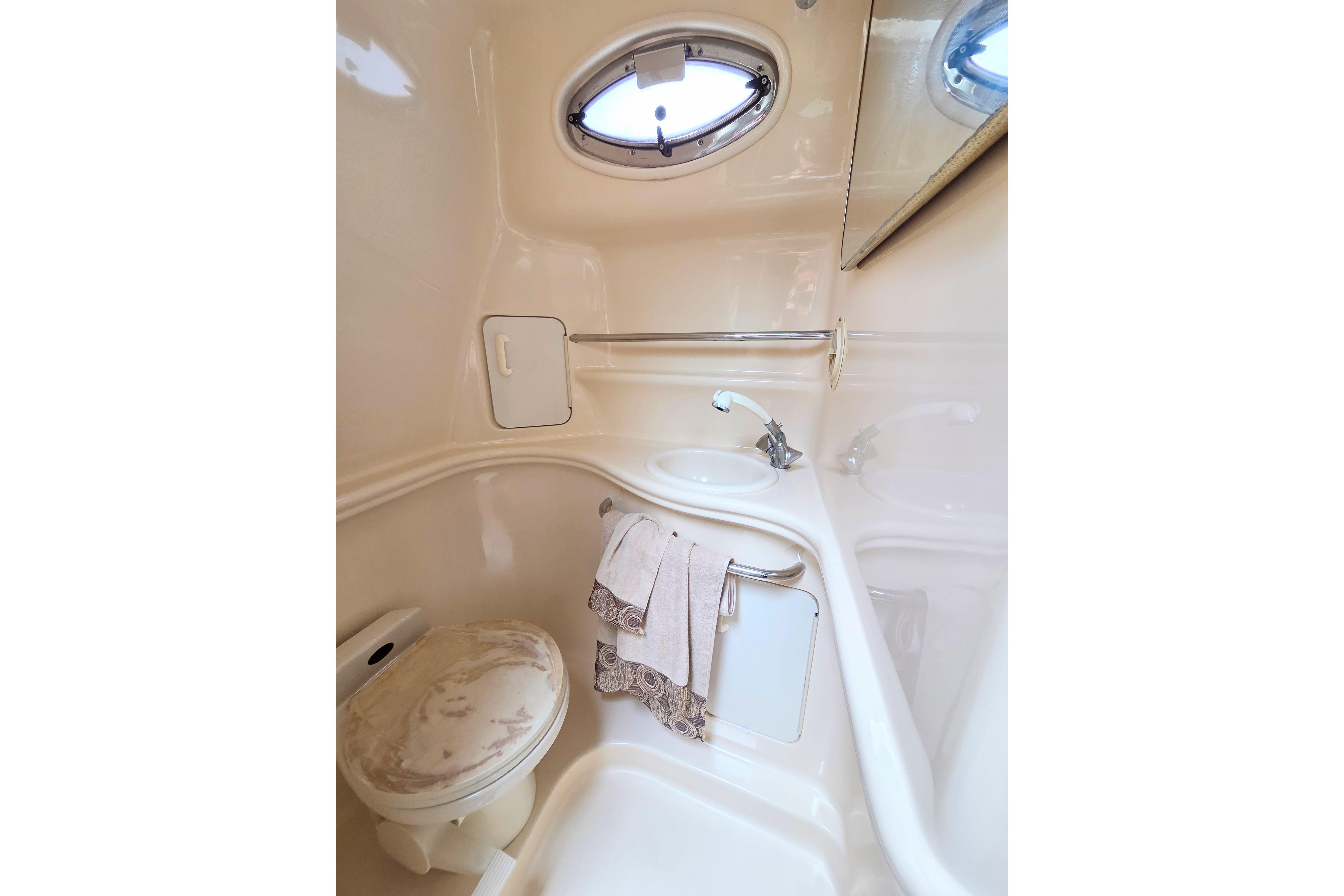 Bathroom interior of 2000 Sea Ray 340 Sundancer yacht, featuring sink and toilet.