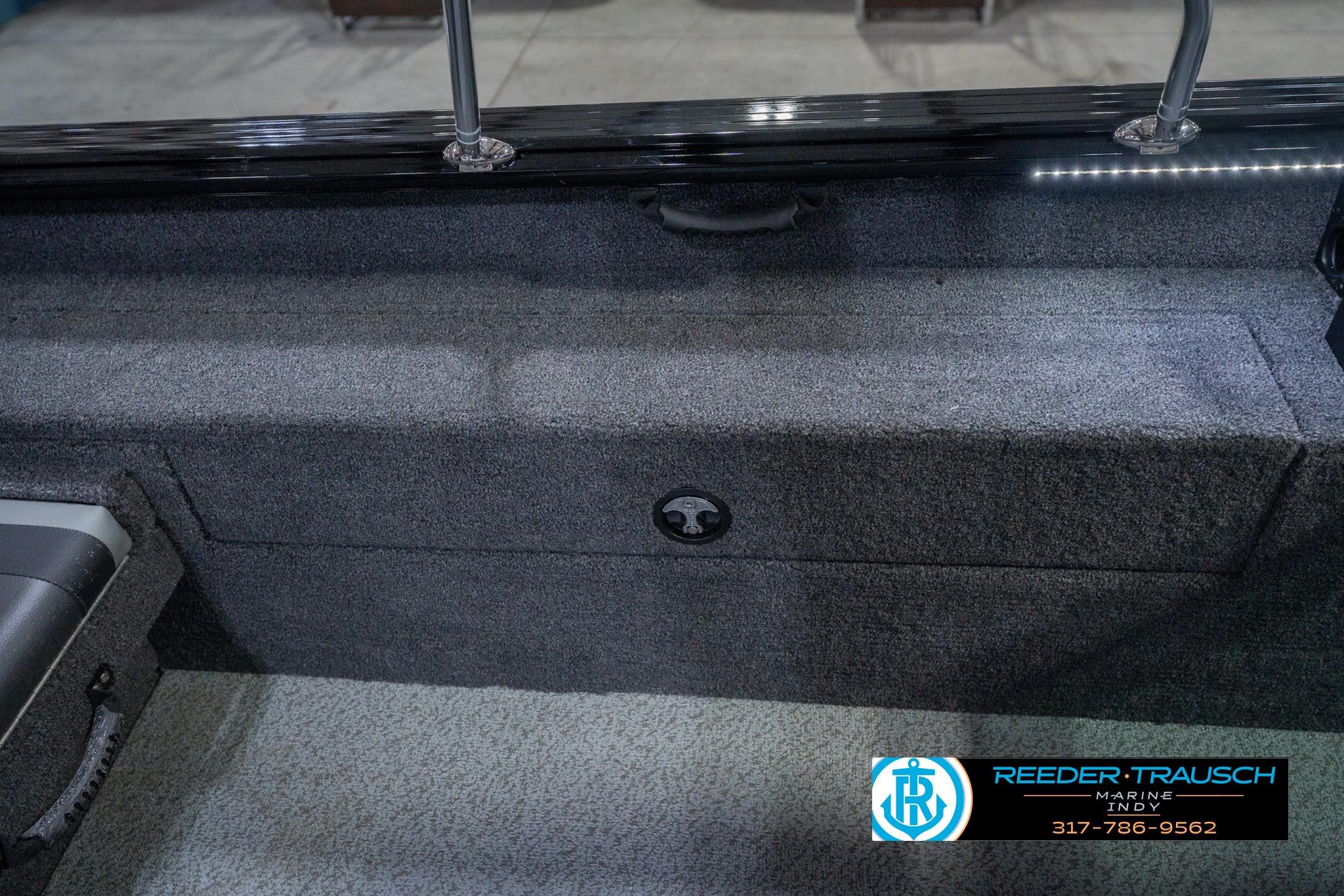2026 Lund 2075 Impact XS boat interior with storage compartment and seating.