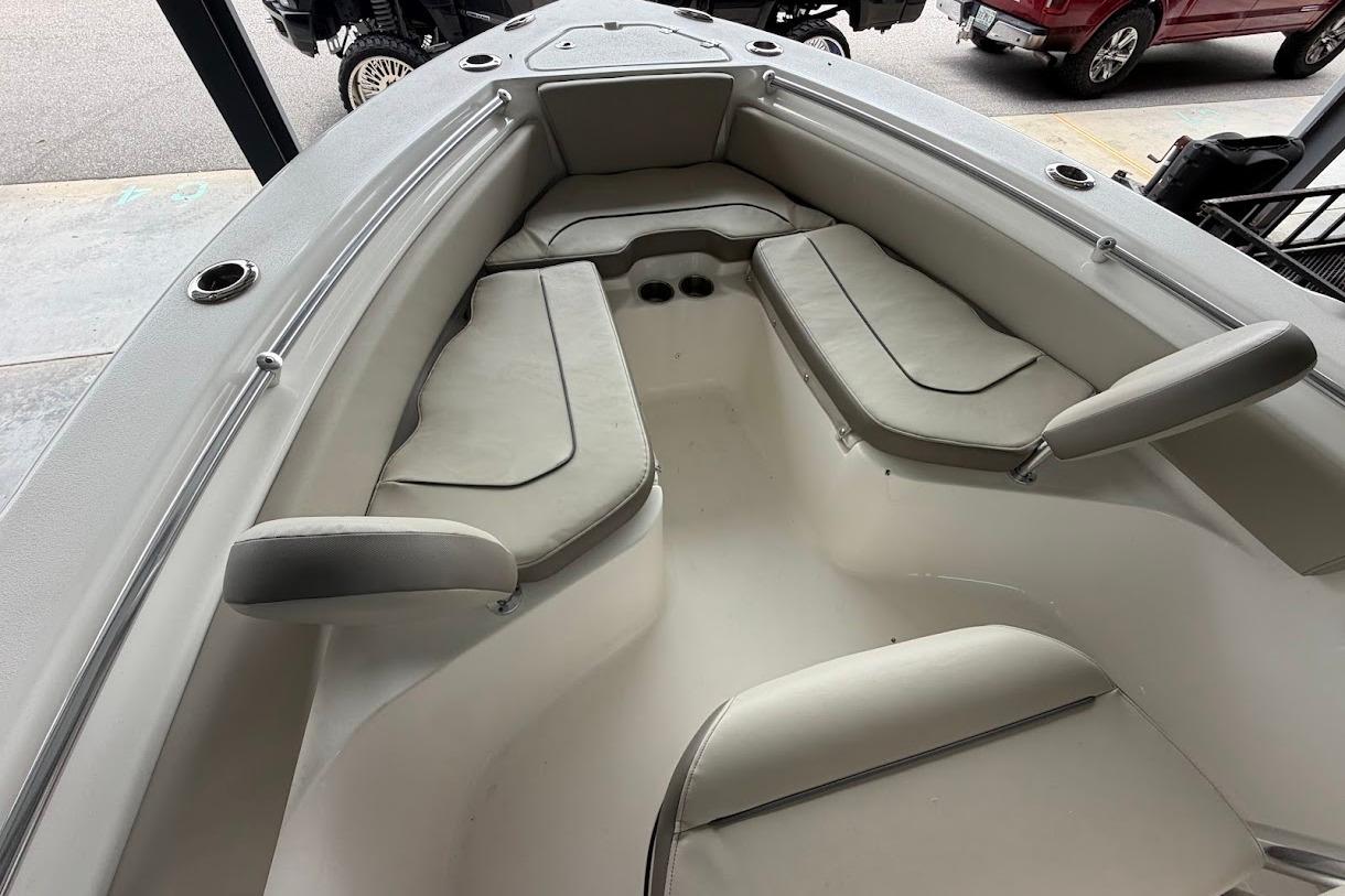 2024 Key West 219 FS boat interior with cushioned seating and cup holders.