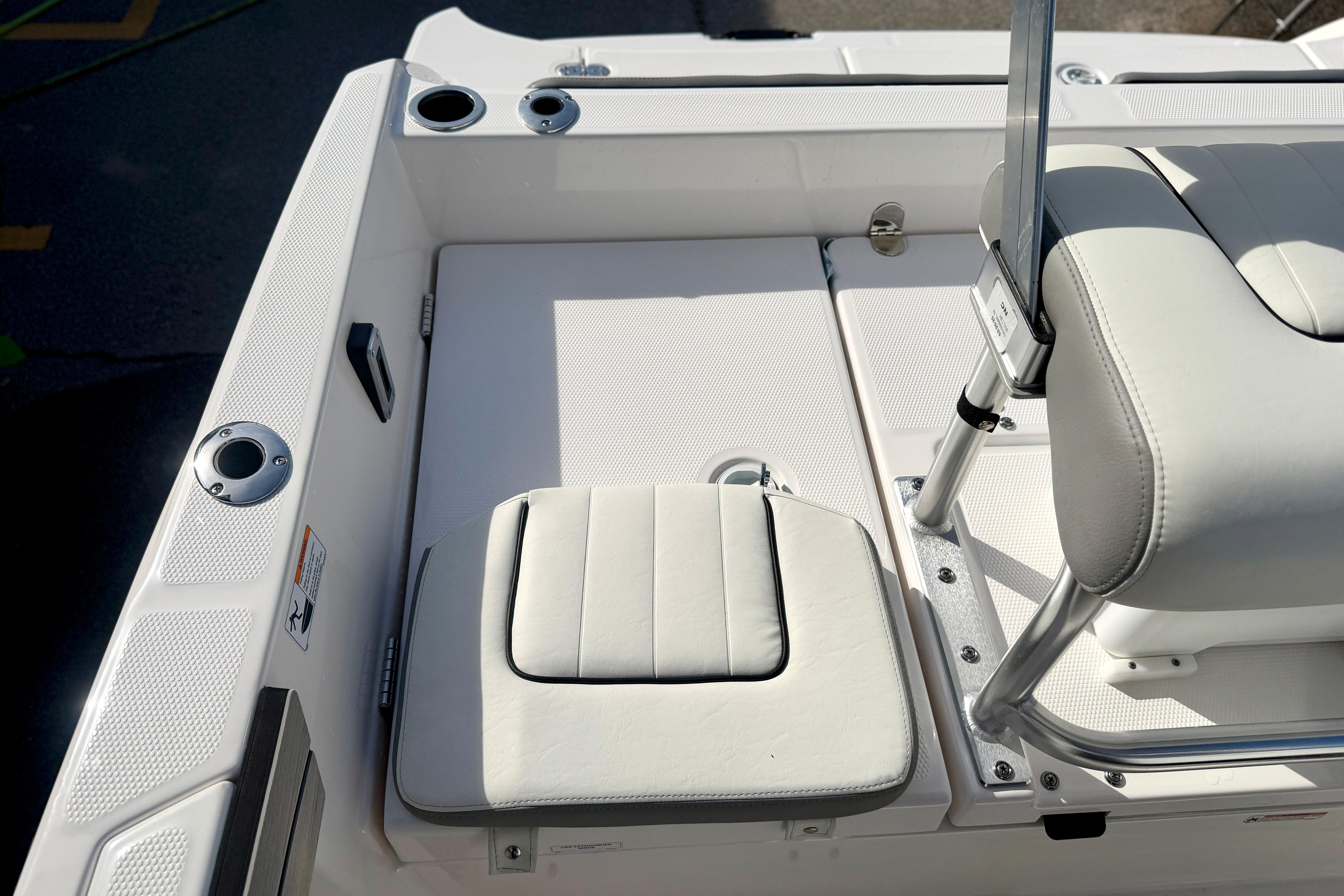2025 Yamaha Boats 195 FSH Sport interior with white seating and stainless steel fixtures.