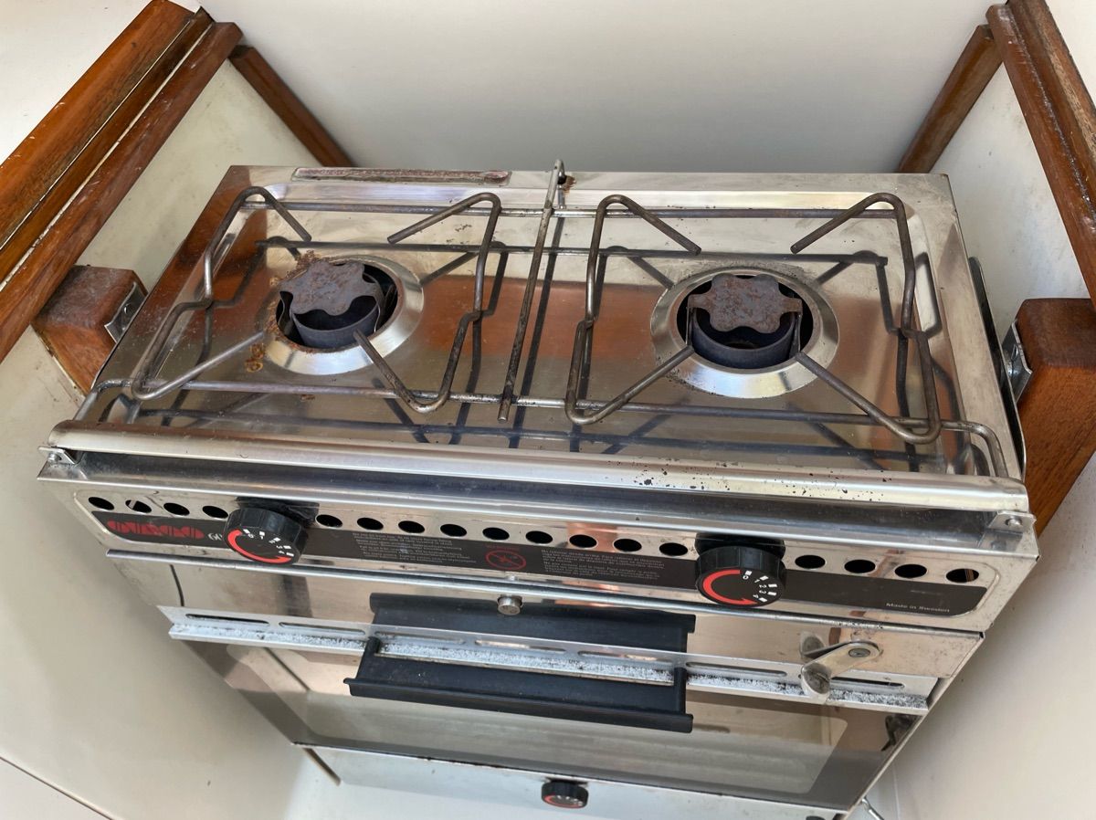 A two-burner stove with oven in a boat's galley.