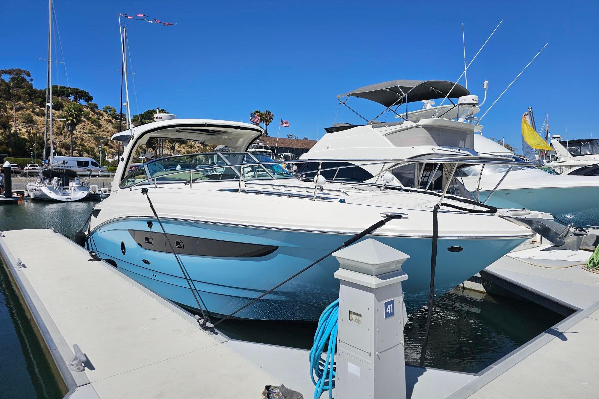 2016 Sea Ray Sundancer 350 yacht docked at marina under clear blue sky.
