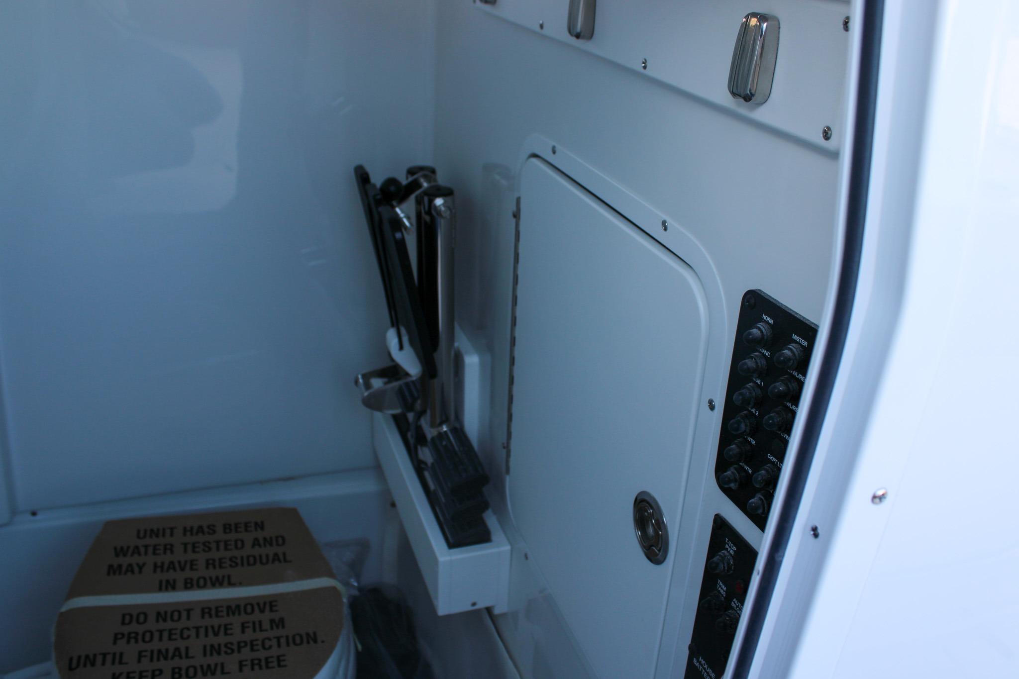 Interior of 2026 Sea Hunt Gamefish 25 boat with control panel and storage.