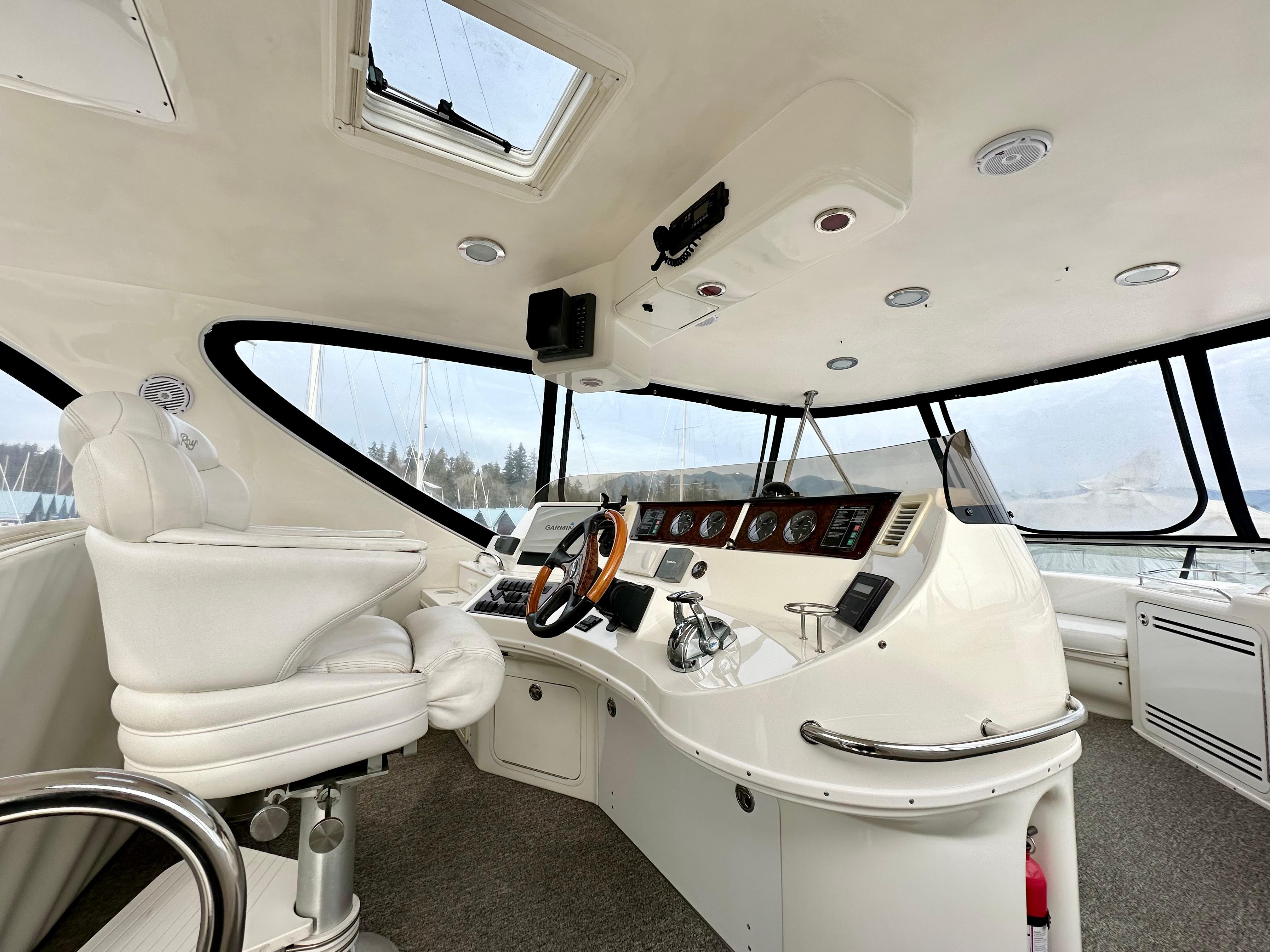 2002 Sea Ray 560 Sedan Bridge helm with white interior and modern controls.