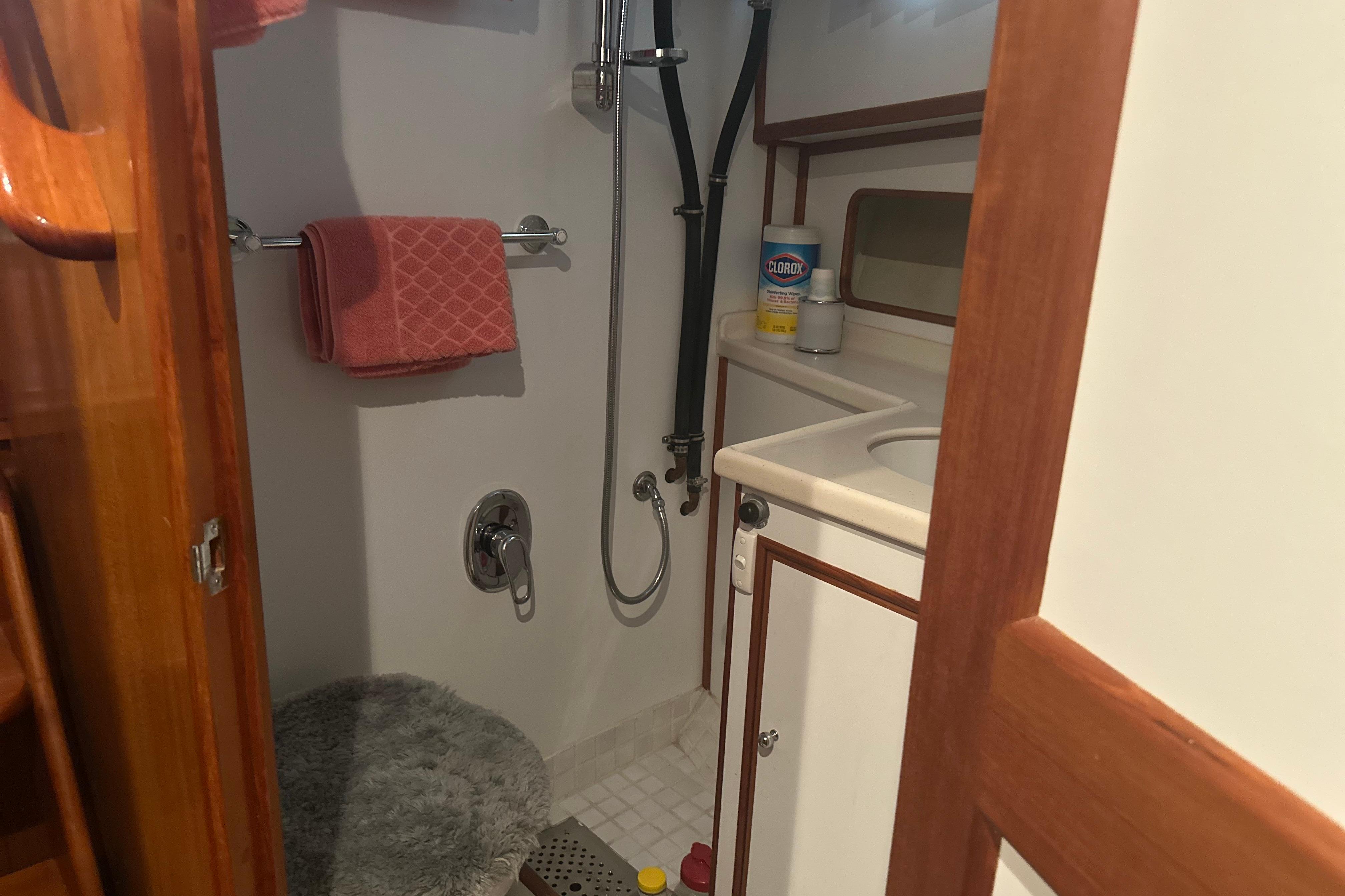 Bathroom interior of 2000 Island Gypsy 36 yacht with shower and sink.
