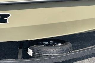 2026 Tracker Pro Team 190 boat on trailer with spare tire visible.