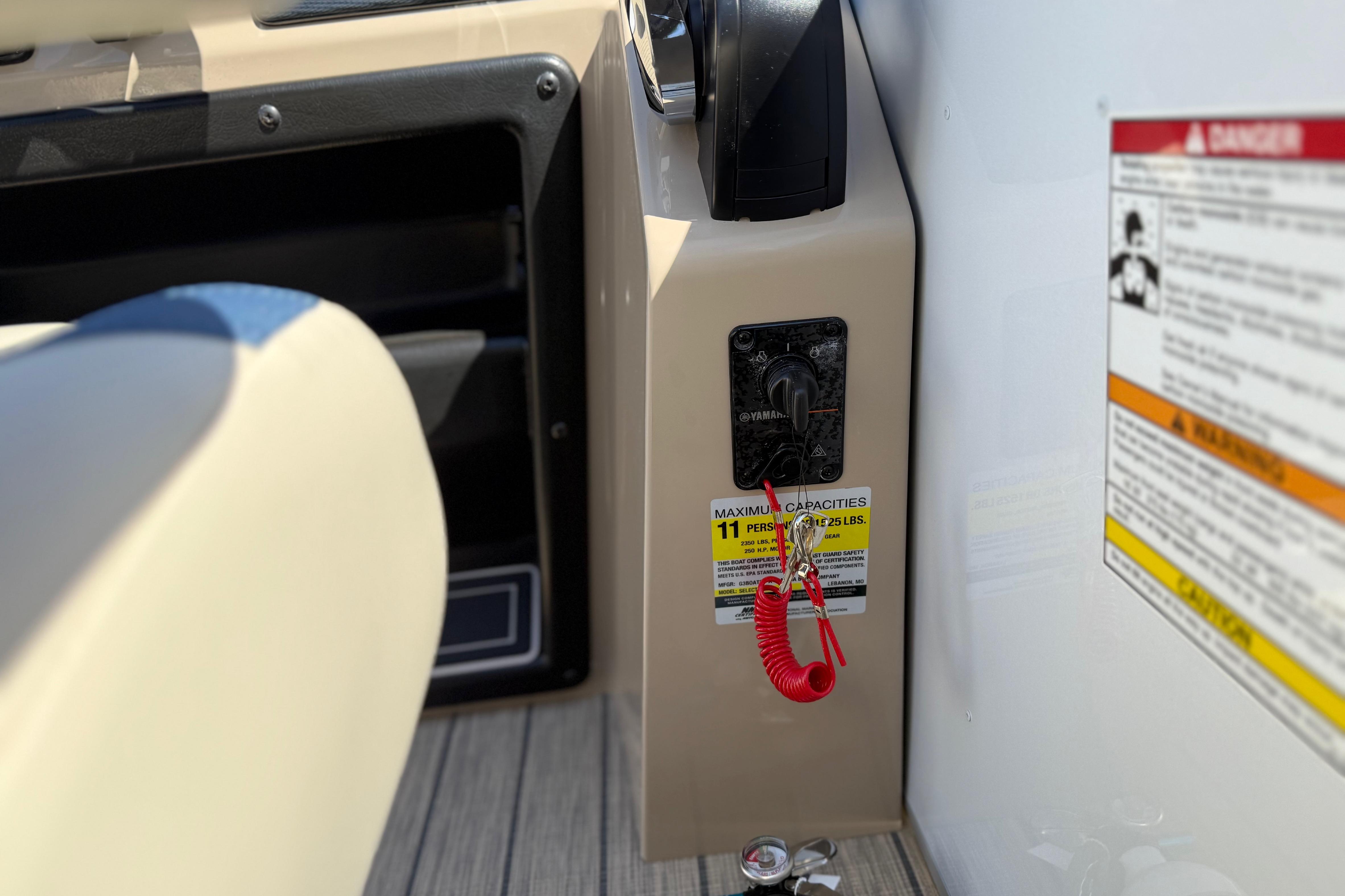 Control panel of 2026 SunCatcher Select 322SL boat with safety key and capacity warning.