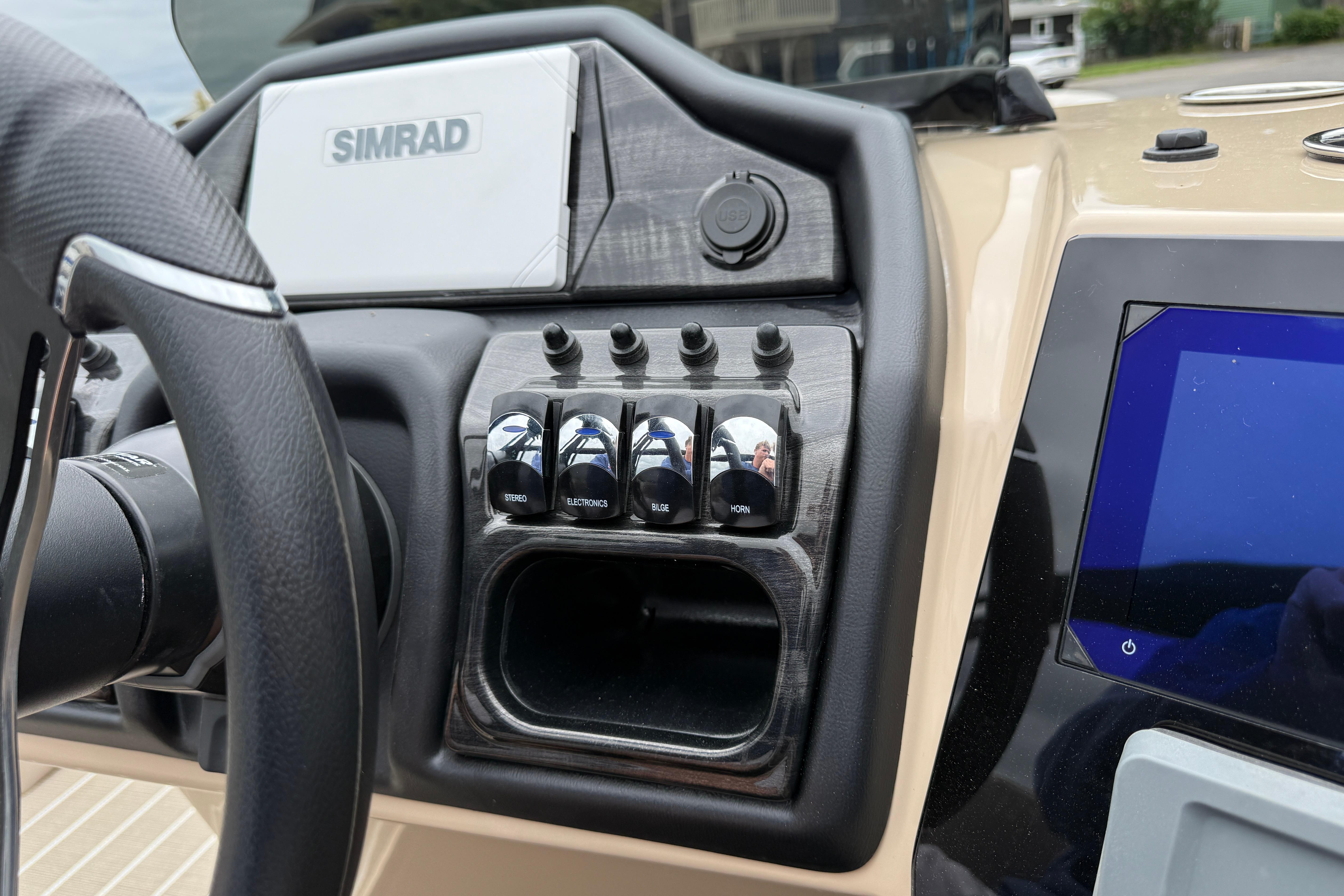 Dashboard of 2026 Bentley Pontoons Elite 253 Admiral with Simrad display and control switches.