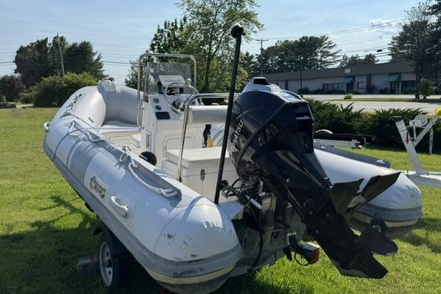 2022 North Atlantic Inflatables RIB420H boat with outboard motor on grassy area.