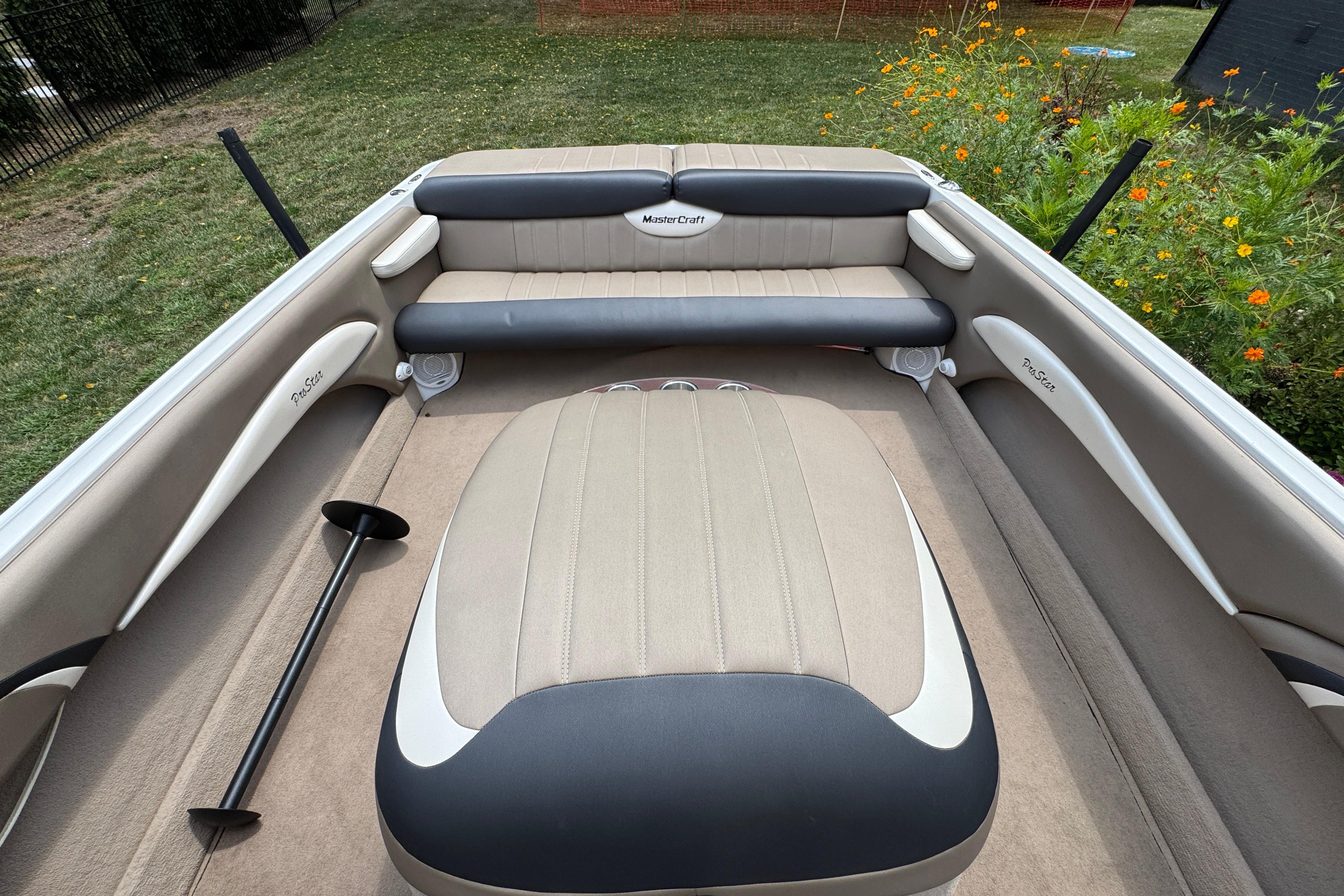 2002 MasterCraft ProStar 209 boat interior with beige and black seating.