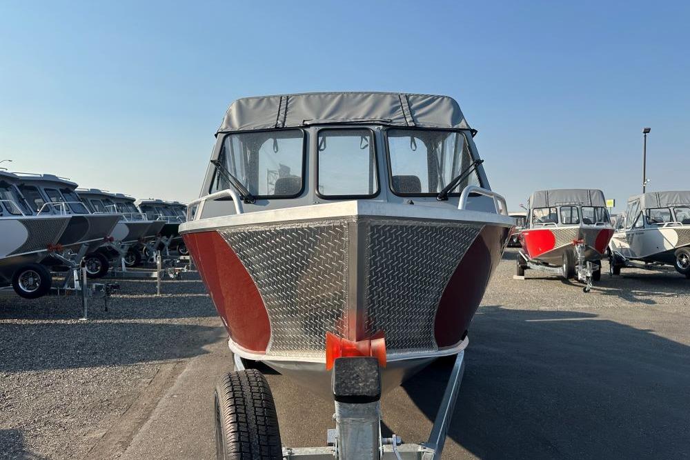 2025 Hewescraft 210 Sea Runner ET boat on trailer, front view, in a dealership lot.