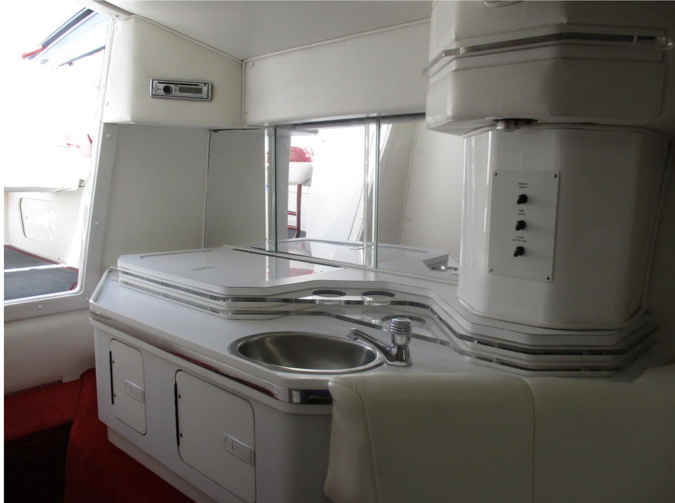 Interior of 2003 Fountain 38 Lightning boat with sink and storage cabinets.