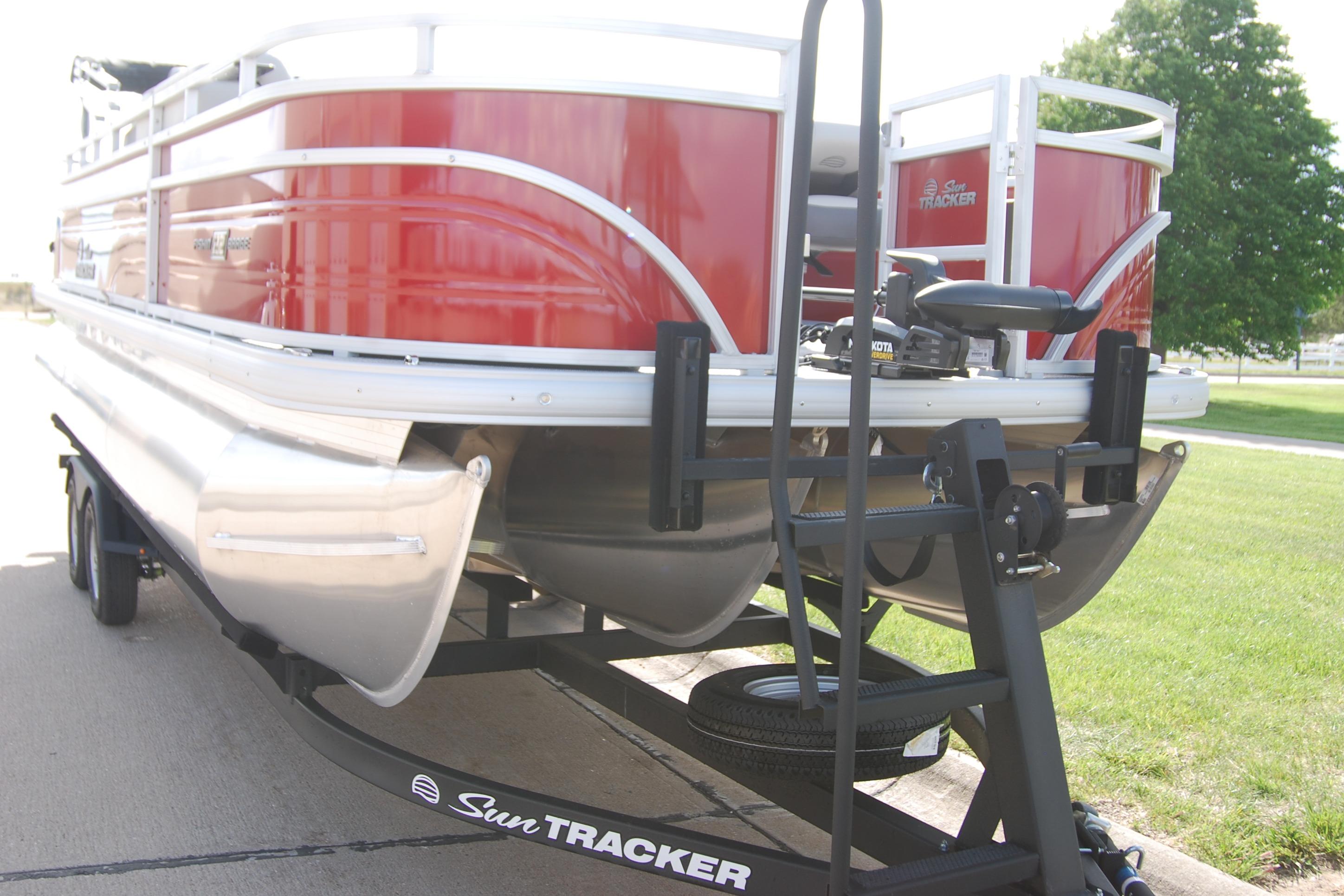 2026 Sun Tracker Fishin' Barge 22 XP3 pontoon boat on trailer, red exterior.