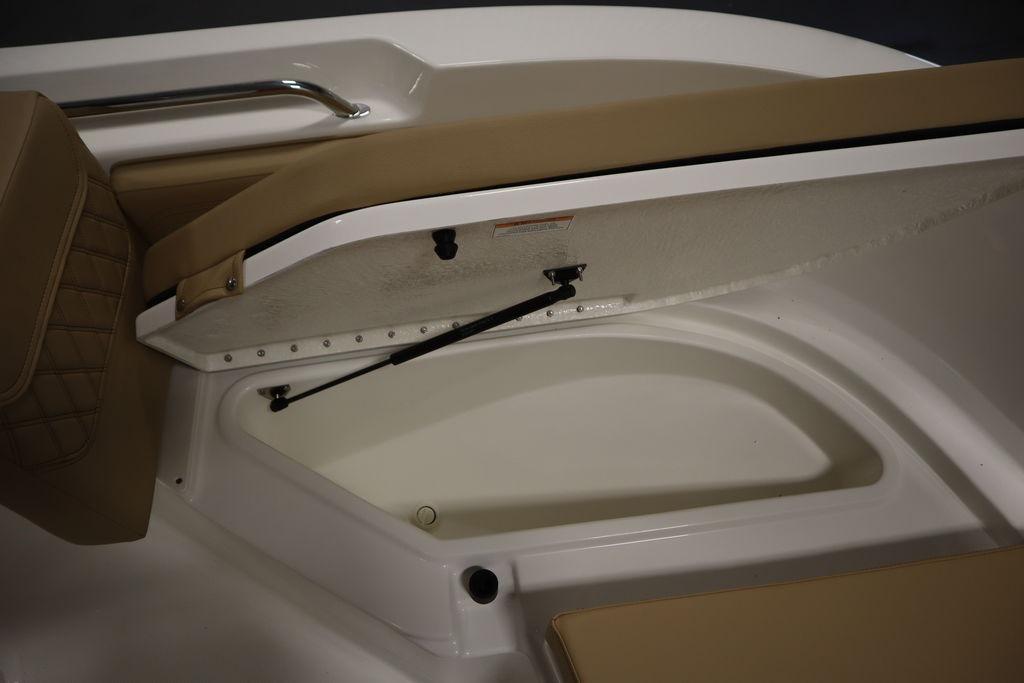 2026 Bayliner Trophy T20CC boat storage compartment with cushioned seating.