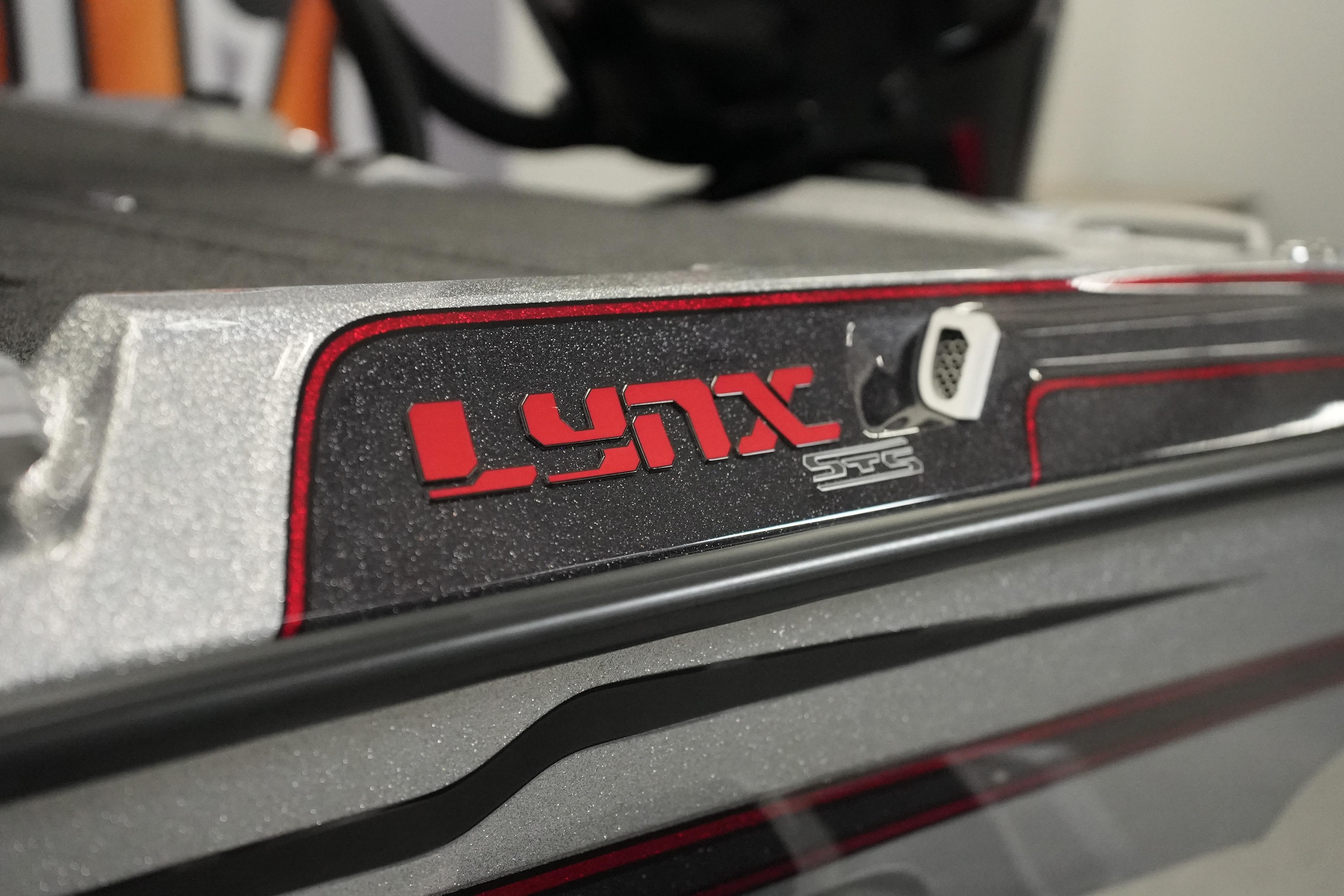 2026 Bass Cat Lynx STS boat detail with red and silver design elements.