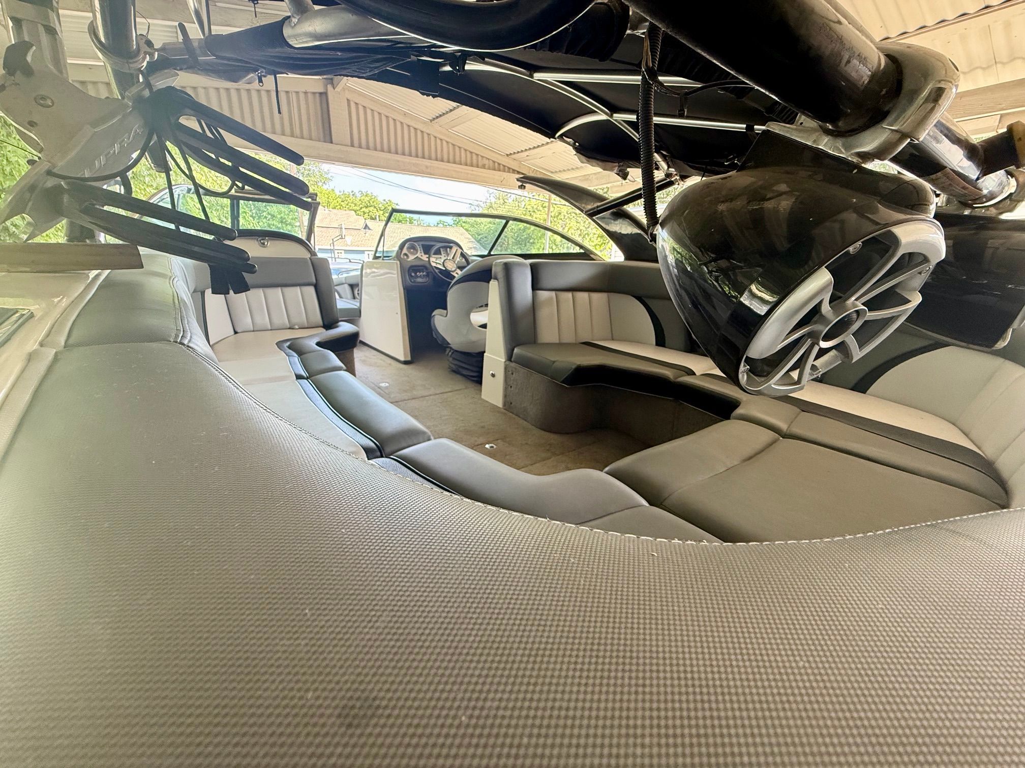 Interior of a 2012 Supra Launch 242 with gray upholstery and a modern helm.