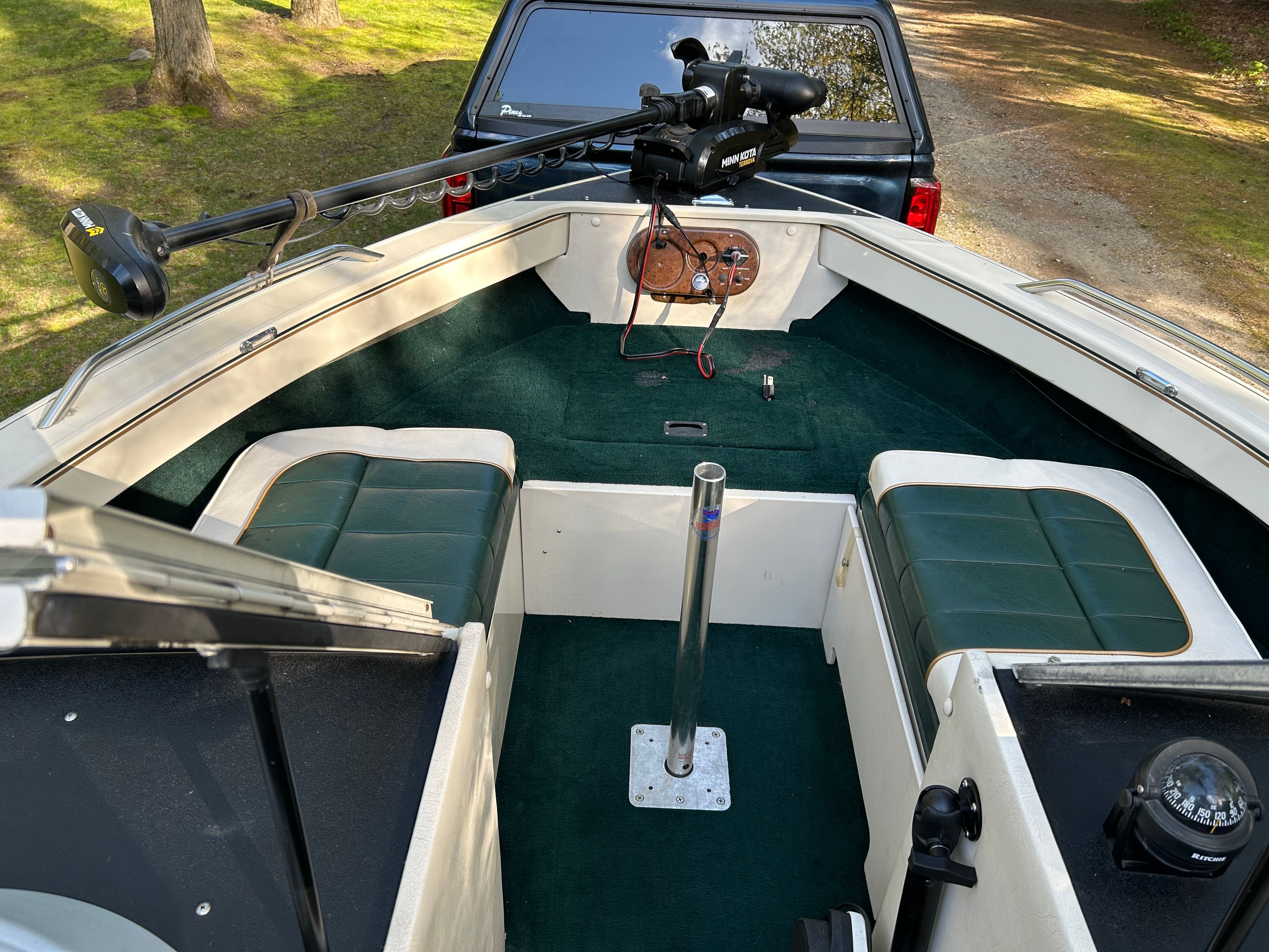 Interior of a 1997 Crestliner 2050 Sportfish boat with green carpet.