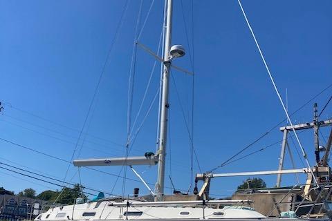 1988 Westerly Corsair 36 sailboat with tall mast against clear blue sky.