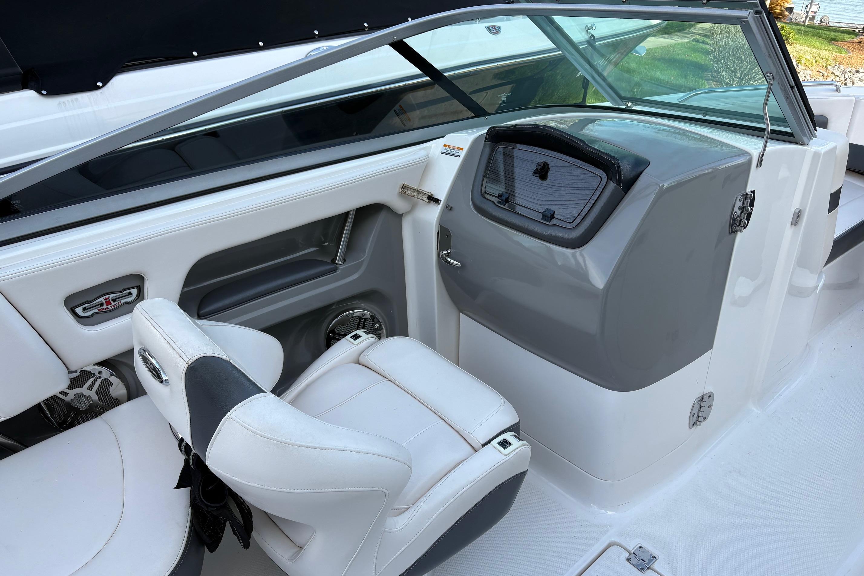 Interior of a 2016 Chaparral 246 SSi boat with white seating and dashboard.