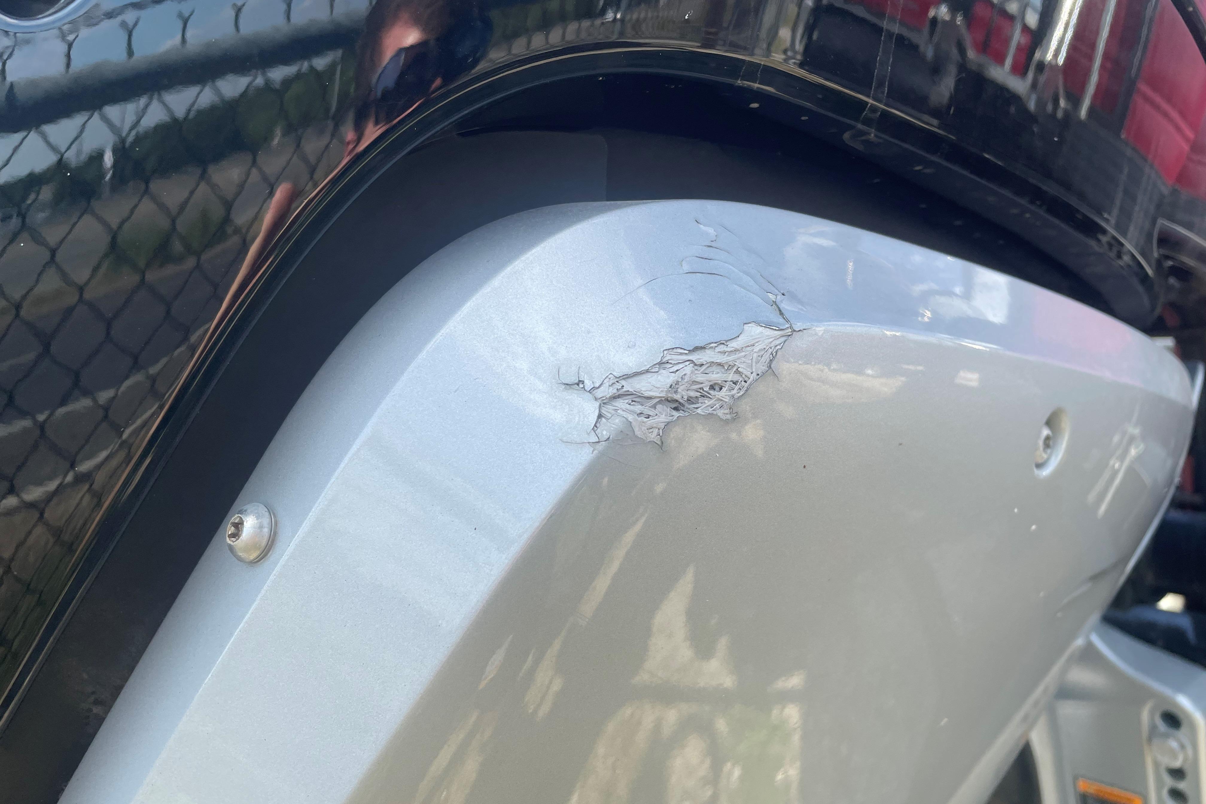 Close-up of damage on a 2023 Regency 250DL3 boat hull.