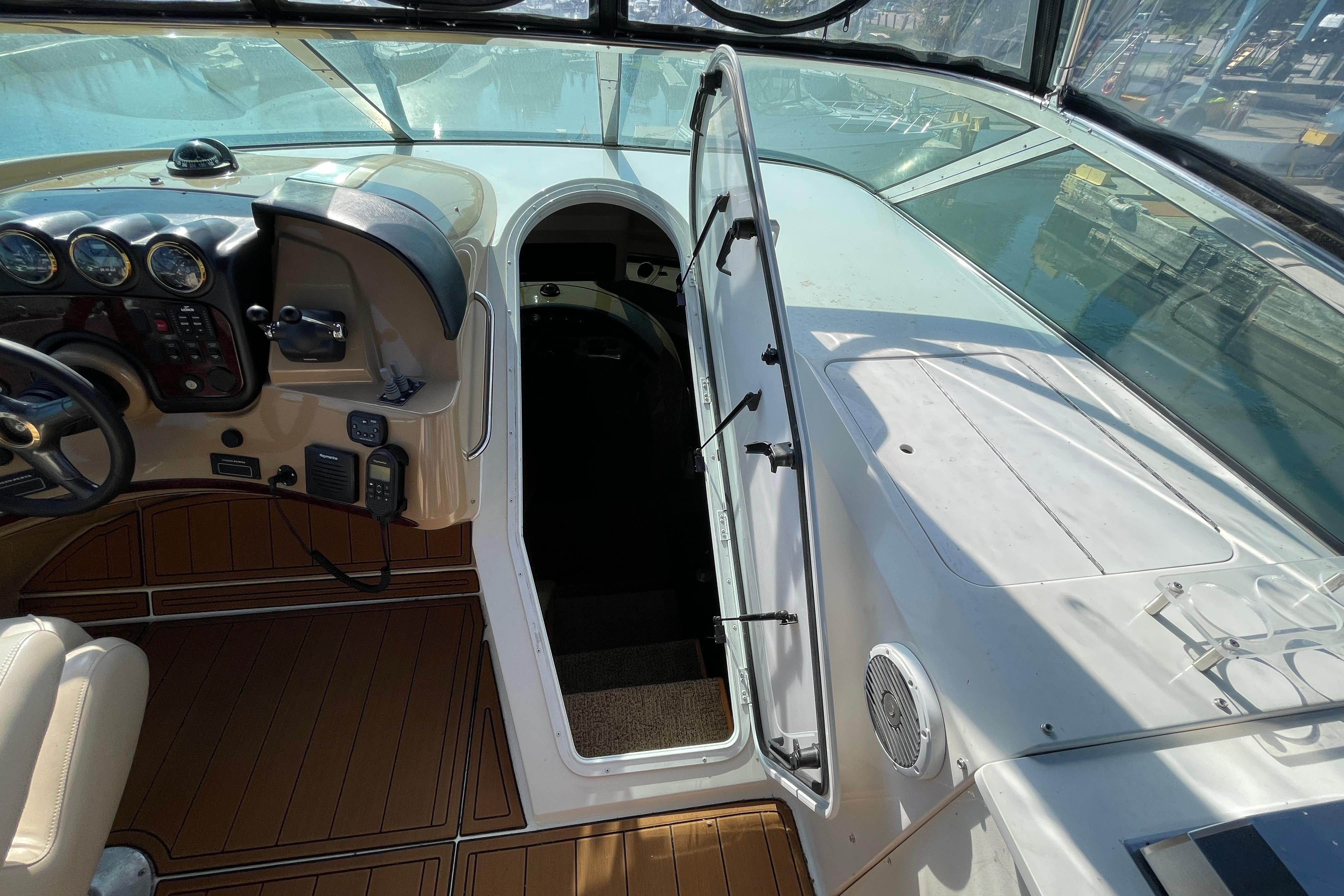 2002 Carver 570 Voyager Pilothouse helm with open hatch, showcasing controls and seating.