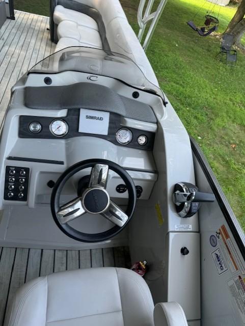 2017 Crest Caribbean 250 L boat dashboard with steering wheel and controls.