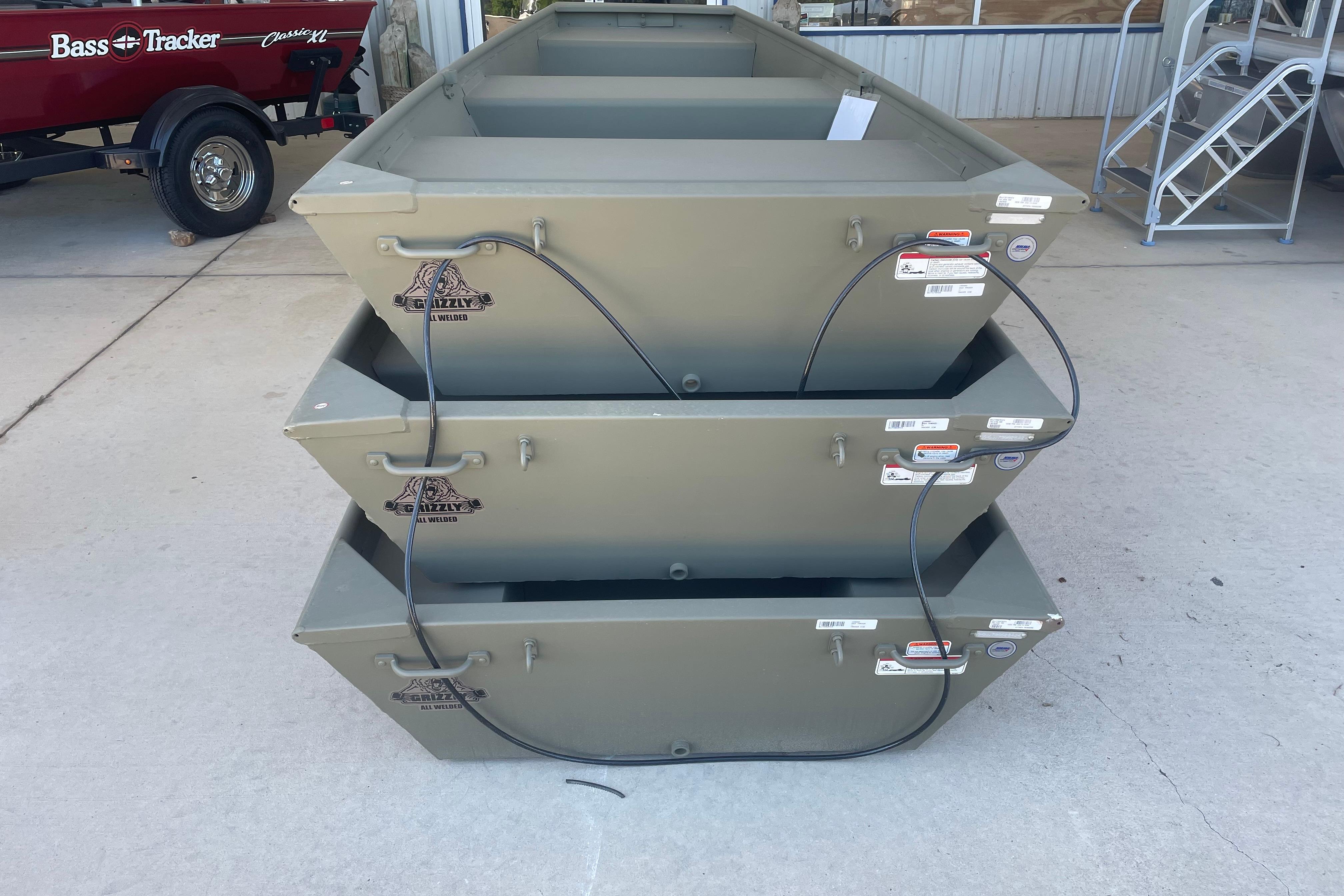 Stacked 2026 Tracker Grizzly 12 Jon boats in a showroom.