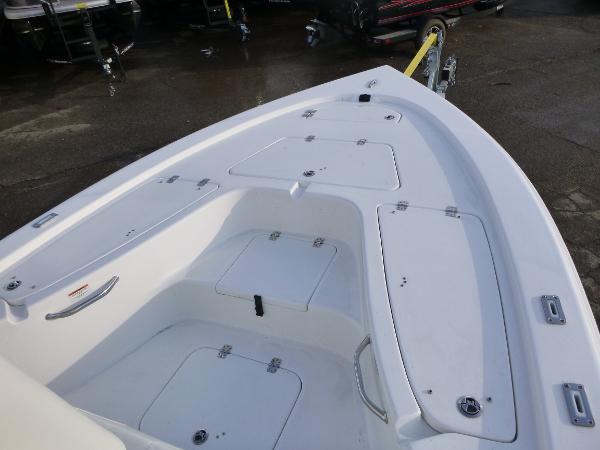 2025 Sea Pro 230 Bay boat deck with storage compartments, shown on a trailer.