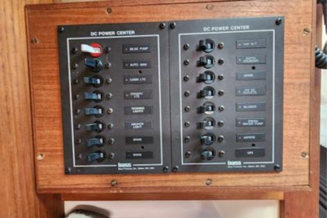 1985 Wasque Down East Cruiser DC power center with labeled switches on a wooden panel.