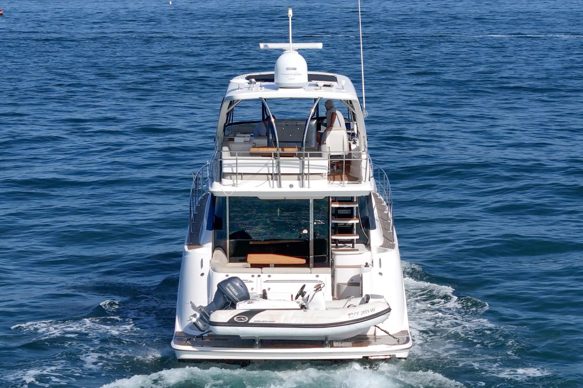 2018 Sea Ray Fly 510 yacht cruising on open water, rear view.