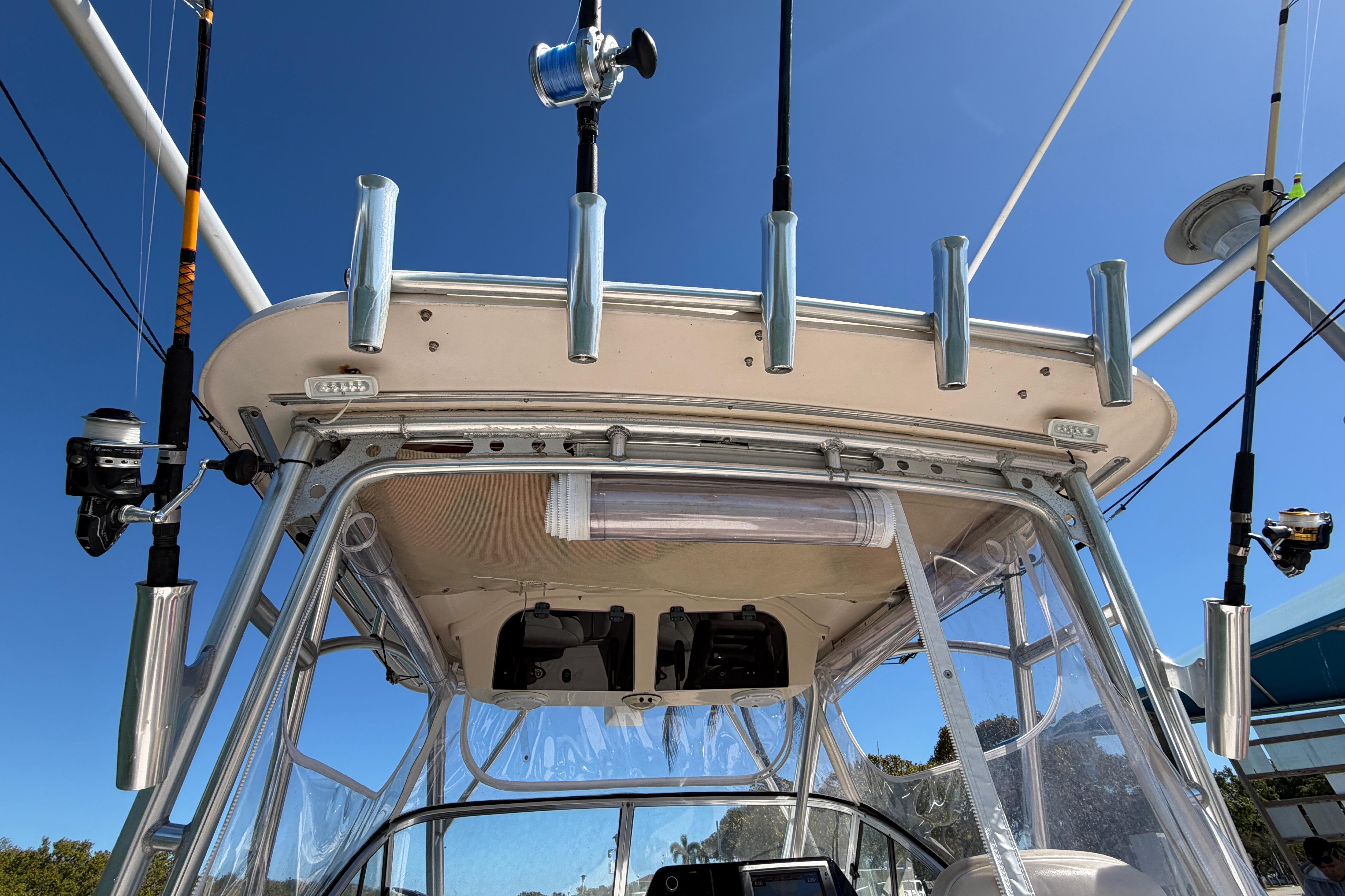 2006 Grady-White Sailfish 282 boat with fishing rods and equipment under clear blue sky.