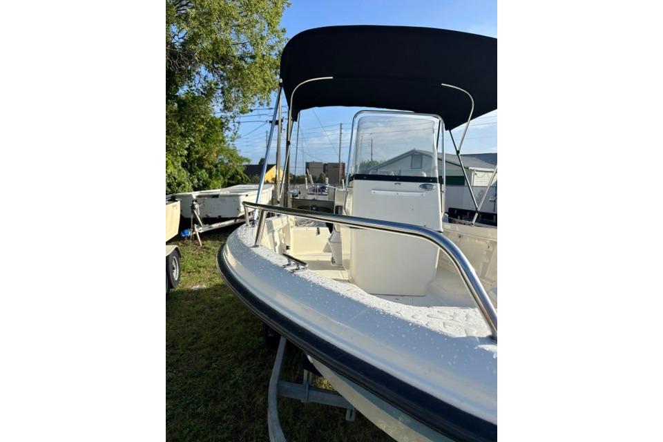 2005 Hydra-Sports Lightning 180 CC boat with canopy, parked on grass.