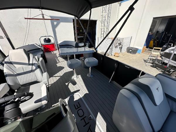 2025 Tahoe Pontoon 2585 LTZ Entertainer interior with seating and table setup.